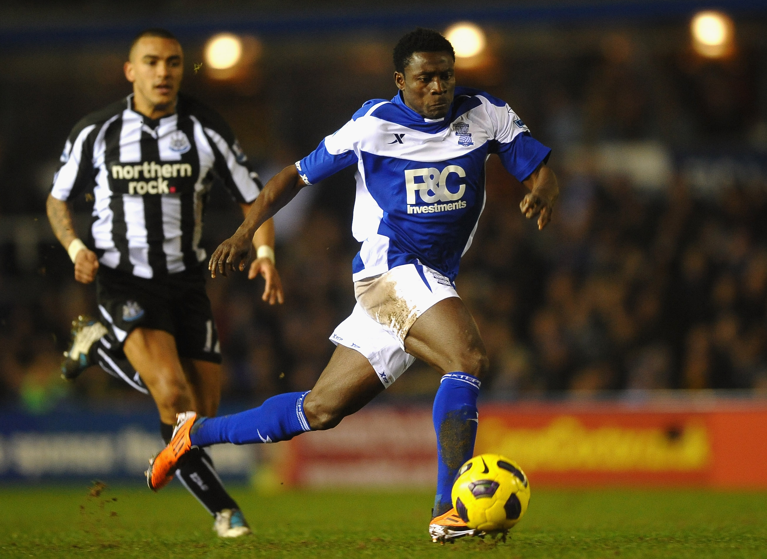 BIRMINGHAM, ENGLAND - FEBRUARY 15: Obafemi Martins of Birmingham City breaks from Danny Simpson of Newcastle United during the Barclays Premier League match between Birmingham City and Newcastle United at St Andrews  on February 15, 2011 in Birmingham, En