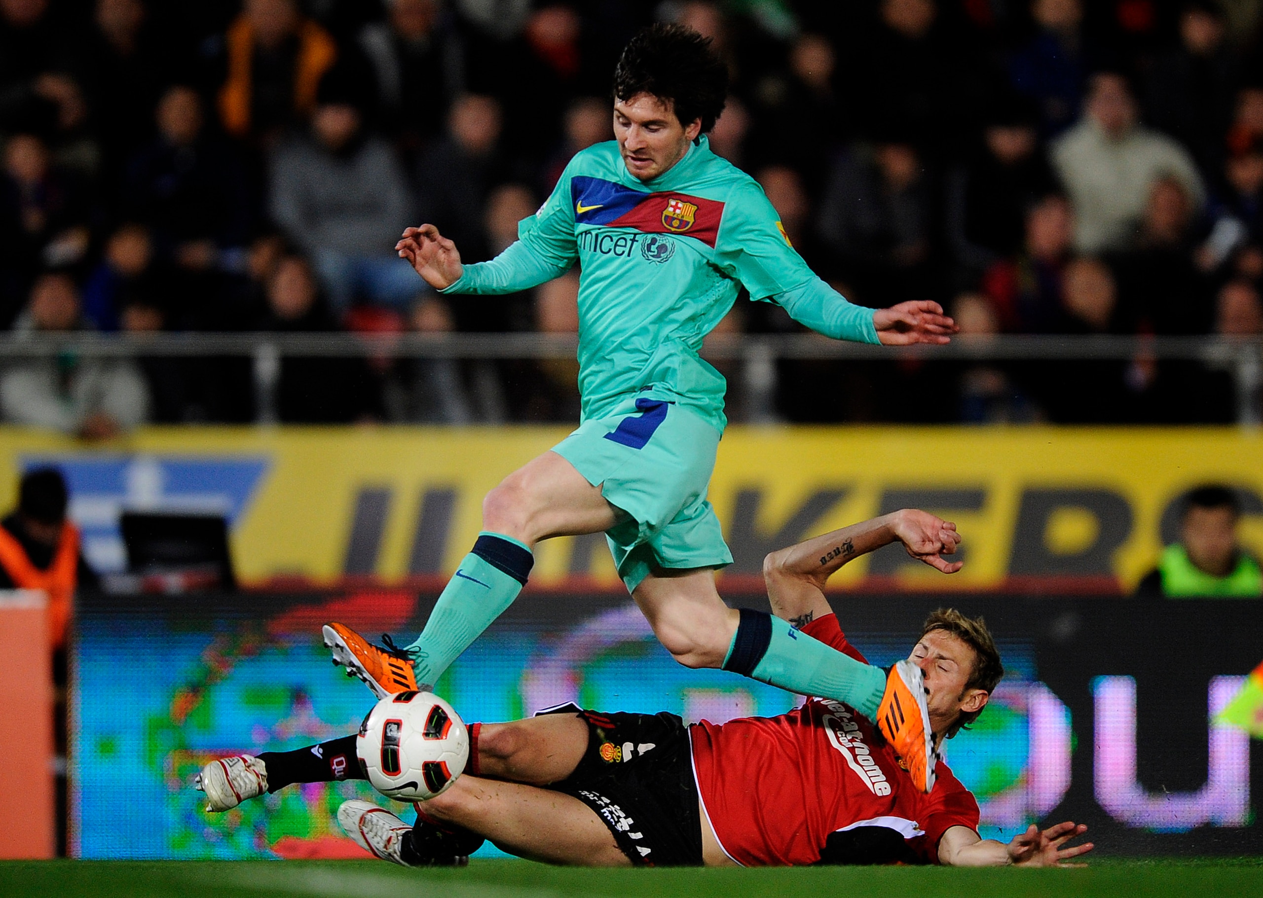 MALLORCA, SPAIN - FEBRUARY 26:  Lionel Messi of FC Barcelona duels for the ball against Ruben Gonzalez of Mallorca during the La Liga match between Mallorca and Barcelona at Iberstar Stadium on February 26, 2011 in Mallorca, Spain. Barcelona won 3-0.  (Ph