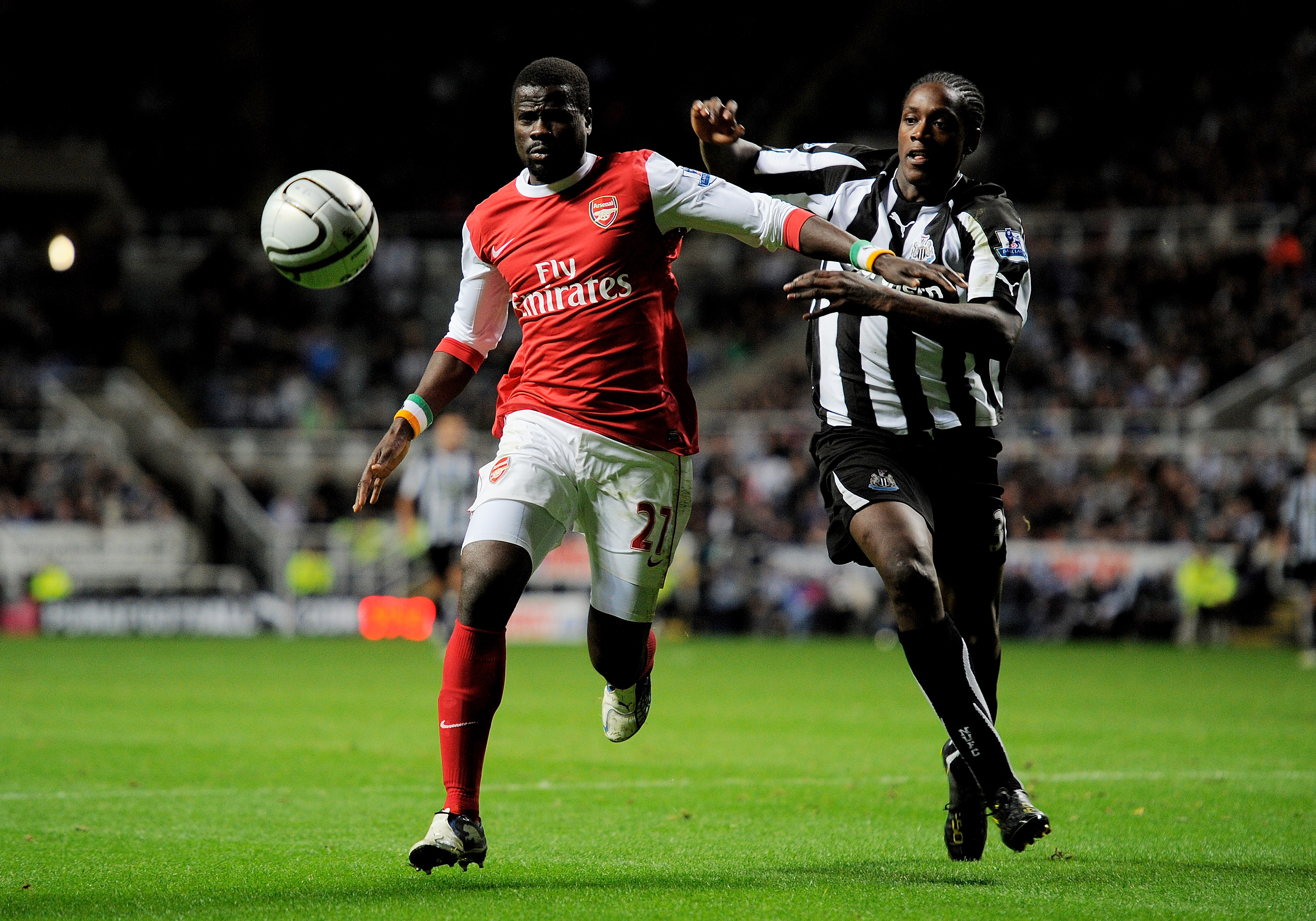 NEWCASTLE UPON TYNE, ENGLAND - OCTOBER 27:  Nile Ranger of Newcastle United competes with Emmanuel Eboue of Arsenal during the Carling Cup Fourth Round match between Newcastle United and Arsenal at St James' Park on October 27, 2010 in Newcastle, England.