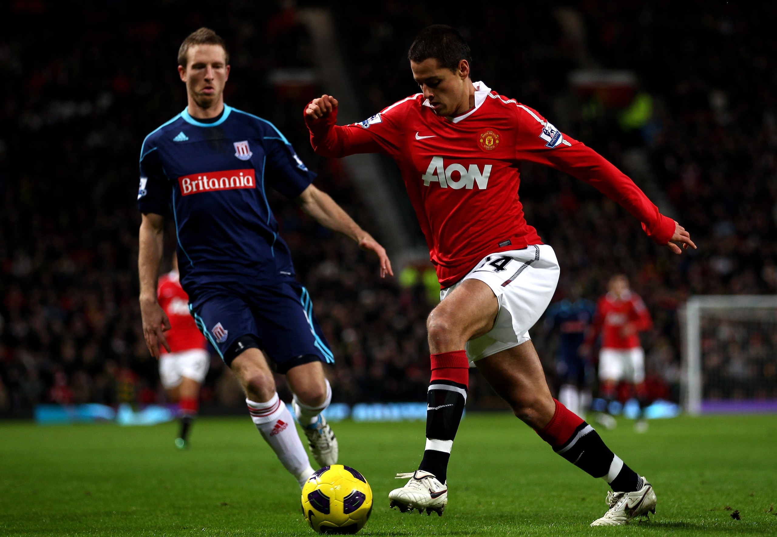 MANCHESTER, ENGLAND - JANUARY 04:  Javier Hernandez of Manchester United competes with Danny Collins of Stoke City during the Barclays Premier League match between Manchester United and Stoke City at Old Trafford on January 4, 2011 in Manchester, England.