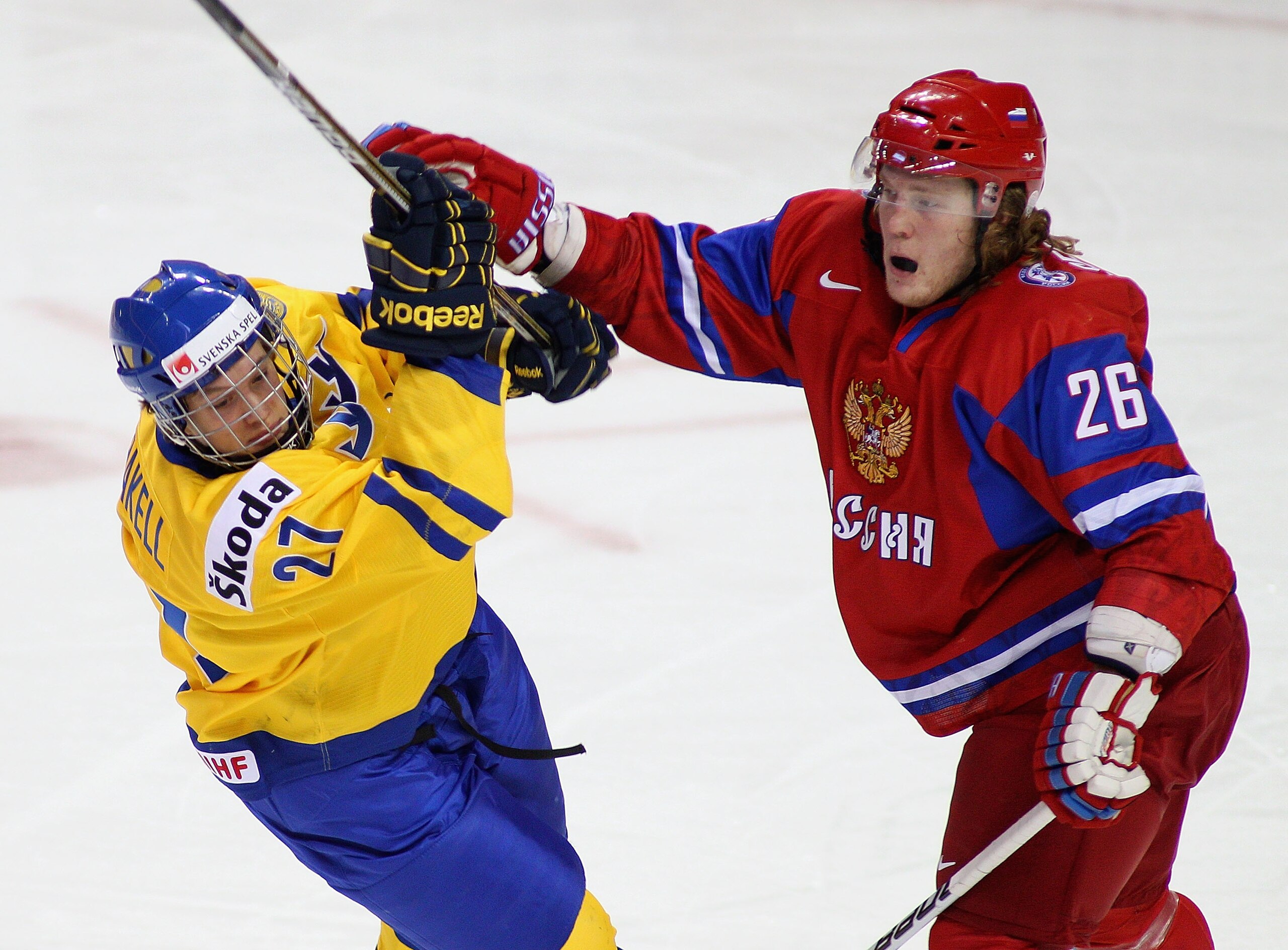 BUFFALO, NY - JANUARY 03: Rickard Rakell #27 of Sweden collides with Andrei Sergeyev #26 of Russia during the 2011 IIHF World U20 Championship Semi Final game between Sweden and Russia on January 3, 2011 in Buffalo, New York. Russia won 4-3 and faces Can BUFFALO, NY - JANUARY 03: Rickard Rakell #27 of Sweden collides with Andrei Sergeyev #26 of Russia during the 2011 IIHF World U20 Championship Semi Final game between Sweden and Russia on January 3, 2011 in Buffalo, New York. Russia won 4-3 and faces Can