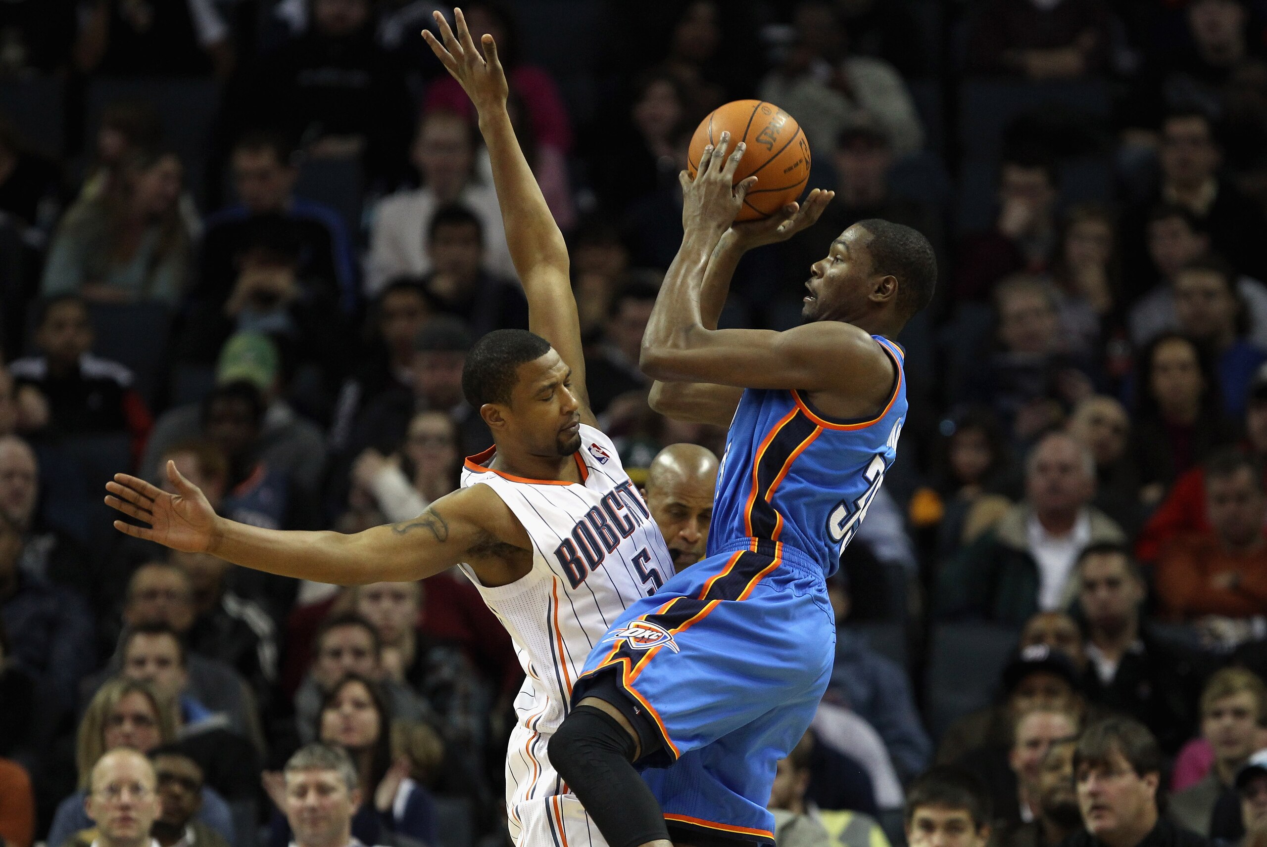 CHARLOTTE, NC - DECEMBER 21:  Kevin Durant #35 of the Oklahoma Thunder shoots the ball over Dominic McGuire #5 of the Charlotte Bobcats during their game at Time Warner Cable Arena on December 21, 2010 in Charlotte, North Carolina. NOTE TO USER: User expr