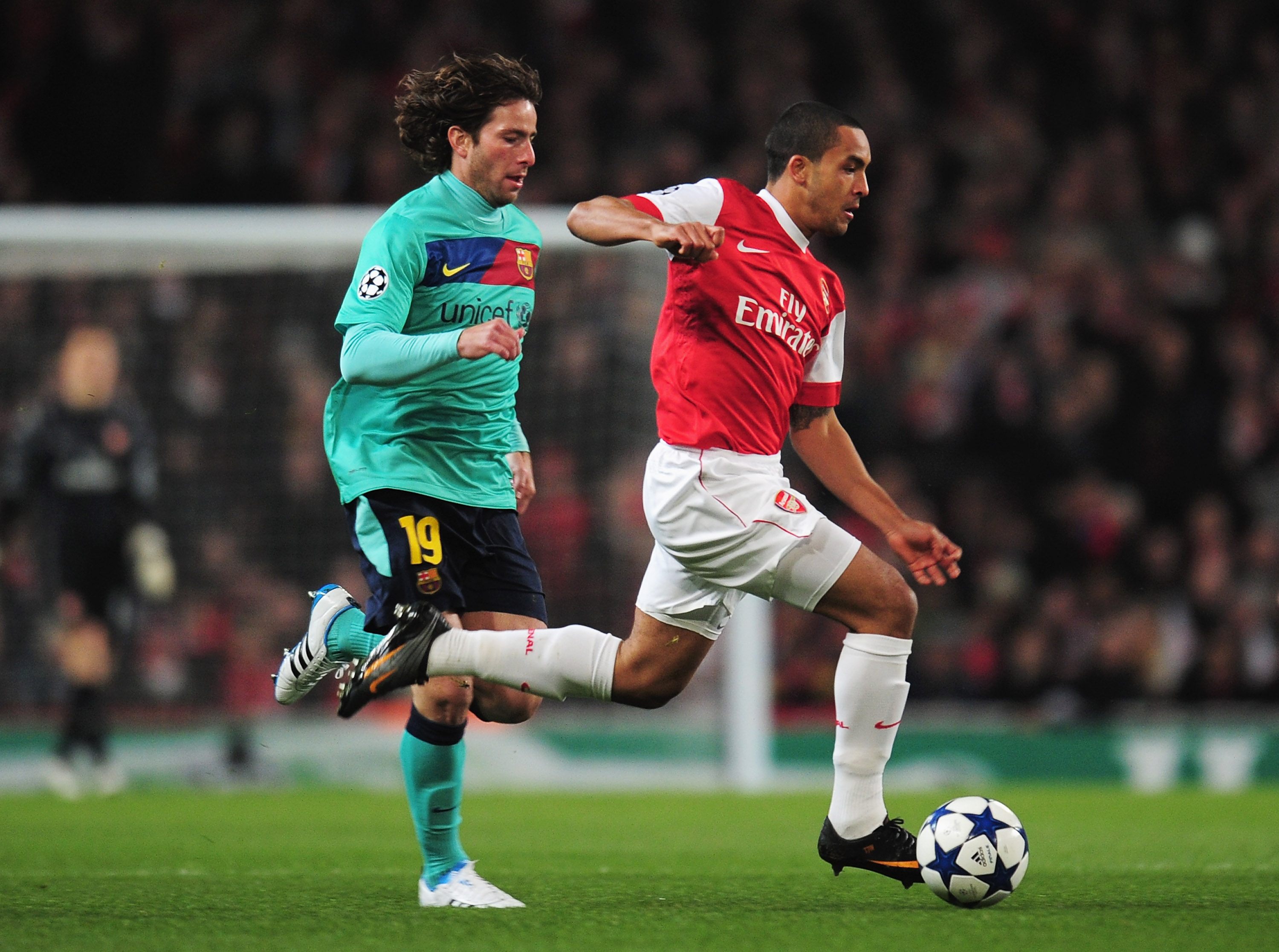 LONDON, ENGLAND - FEBRUARY 16: Theo Walcott of Arsenal goes past Maxwell of Barcelona during the UEFA Champions League round of 16 first leg match between Arsenal and Barcelona at the Emirates Stadium on February 16, 2011 in London, England.  (Photo by Sh
