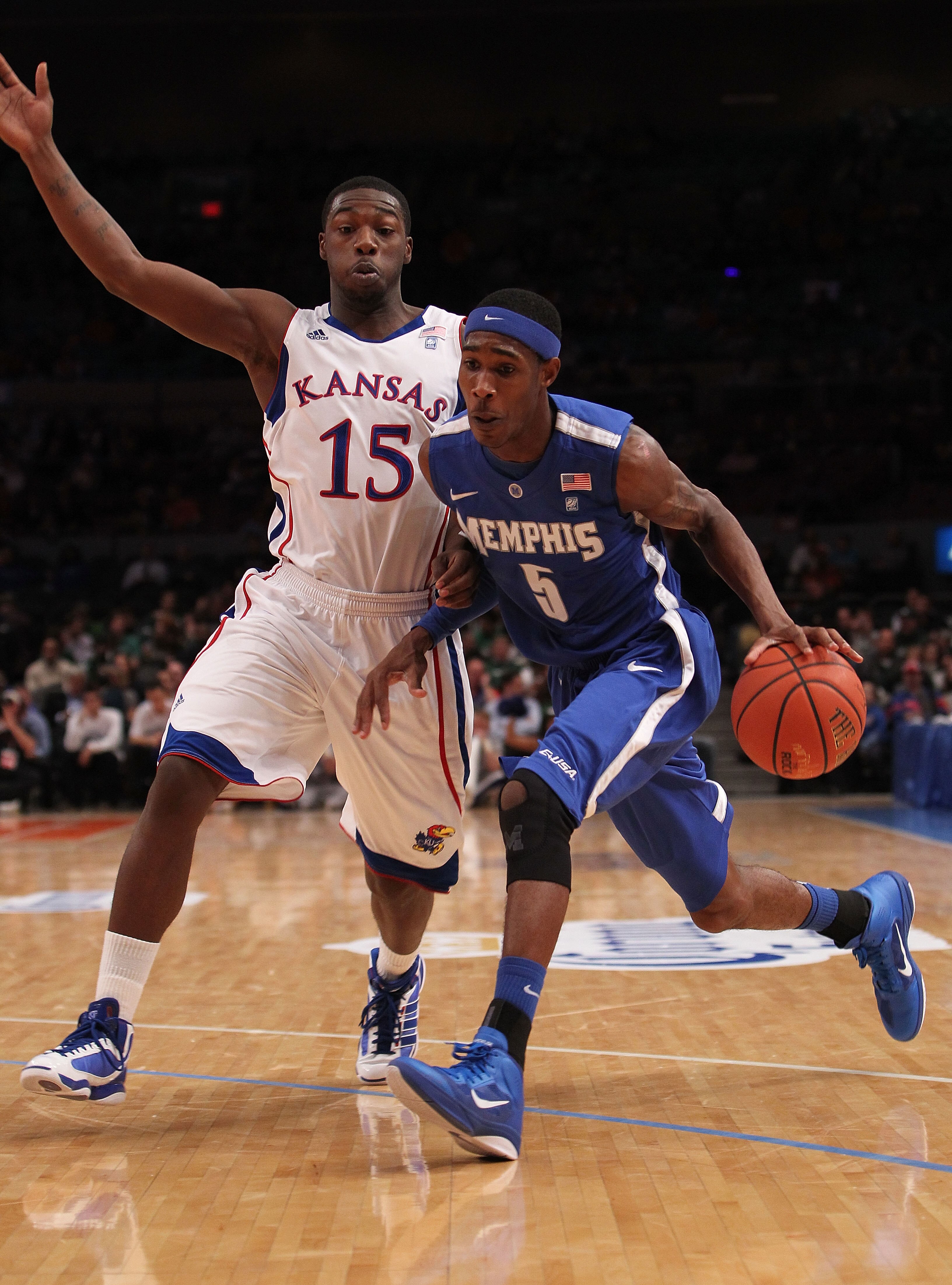 NEW YORK, NY - DECEMBER 07: Will Barton #5 of the Memphis Tigers drives to the basket against Elijah Johnson #15 of the Kansas Jayhawks during their game at the Jimmy V Classic at Madison Square Garden on December 7, 2010 in New York City.  (Photo by Nick