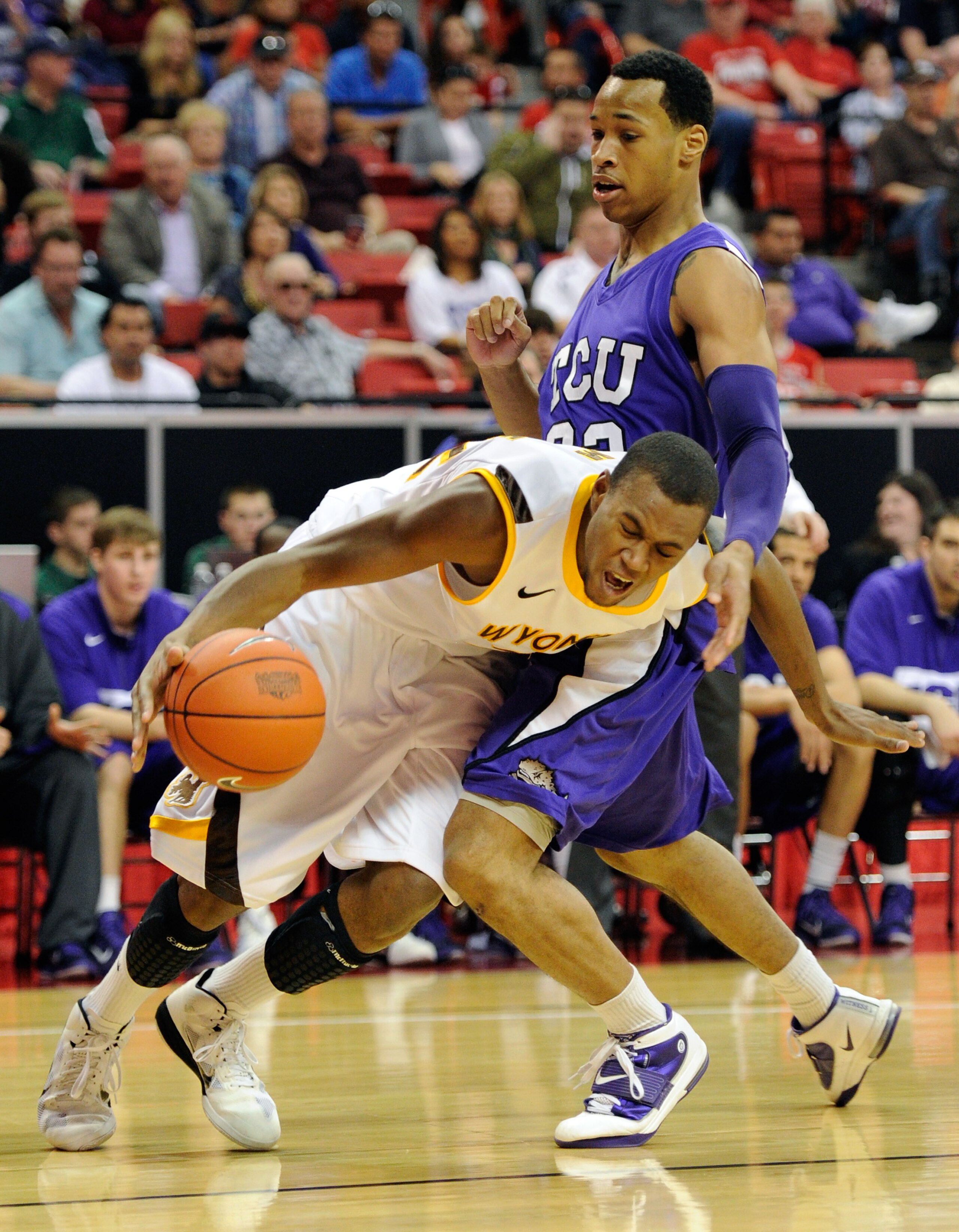 LAS VEGAS, NV - MARCH 09:  Garlon Green #33 of the Texas Christian University Horned Frogs fouls Amath M'Baye #22 of the Wyoming Cowboys during the first round of the Conoco Mountain West Conference Basketball tournament at the Thomas & Mack Center March