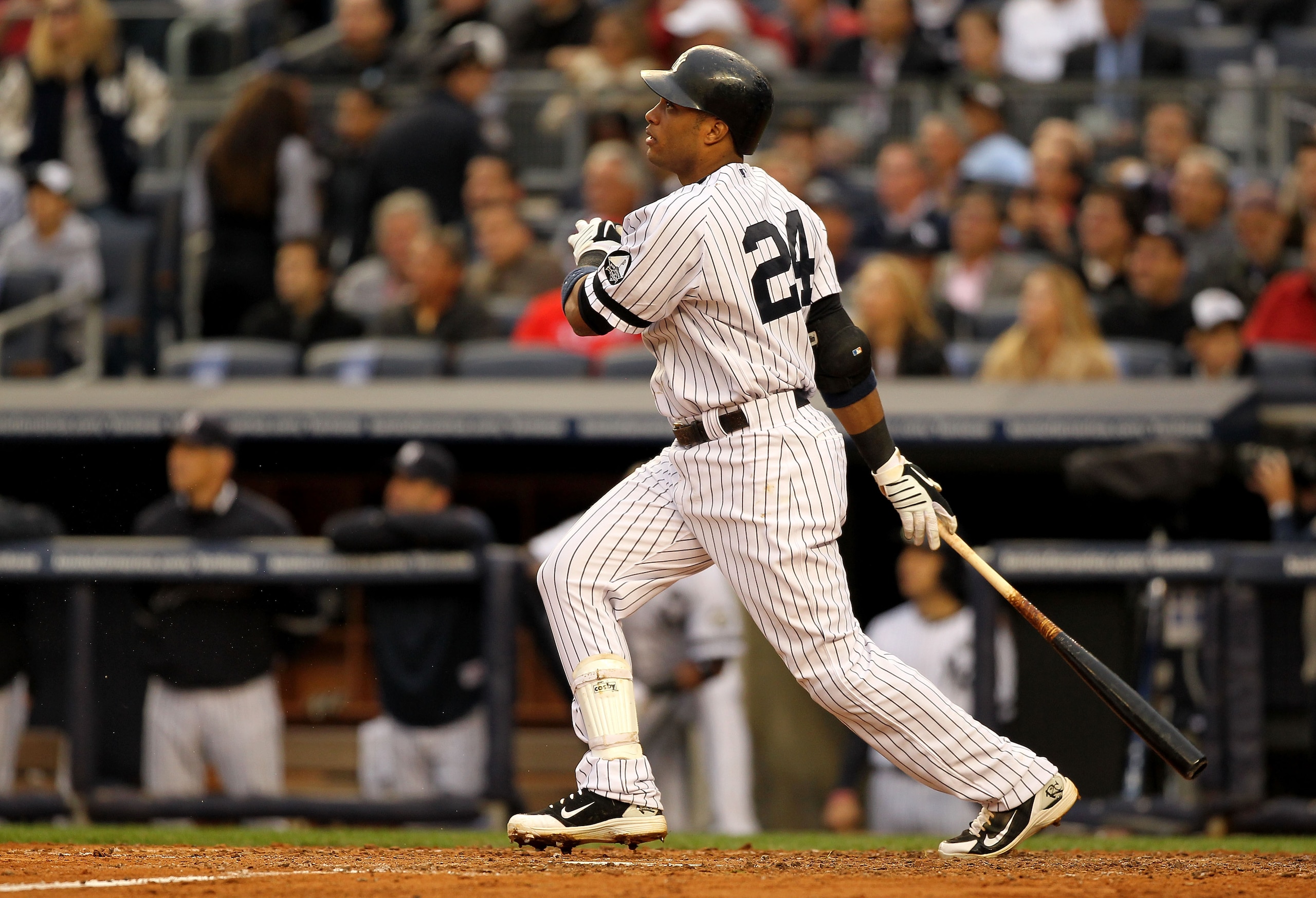 NEW YORK - OCTOBER 20:  Robinson Cano #24 of the New York Yankees hits a solo homerun in the third inning against the Texas Rangers in Game Five of the ALCS during the 2010 MLB Playoffs at Yankee Stadium on October 20, 2010 in the Bronx borough of New Yor