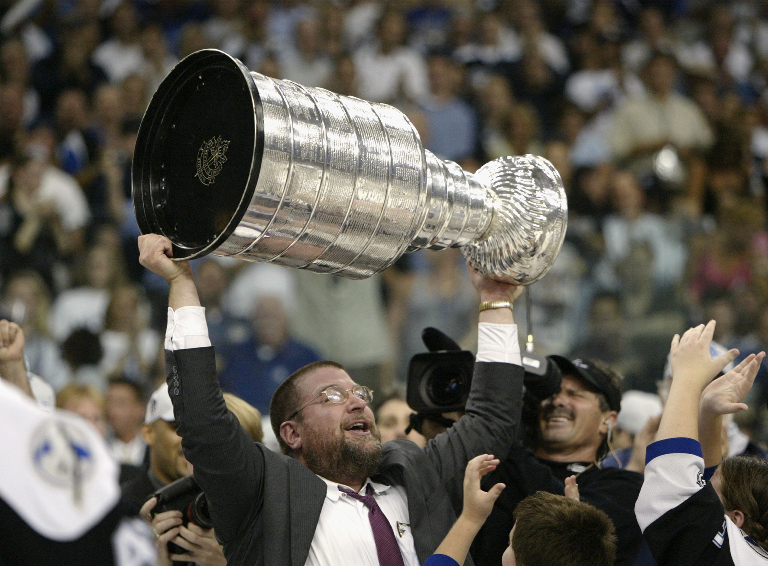 TAMPA, FL - JUNE 7:  Executive Vice President and General Manager Jay Feaster of the Tampa Bay Lightning holds the Stanley Cup above his head after the victory over the Calgary Flames in Game seven of the NHL Stanley Cup Finals on June 7, 2004 at the St.