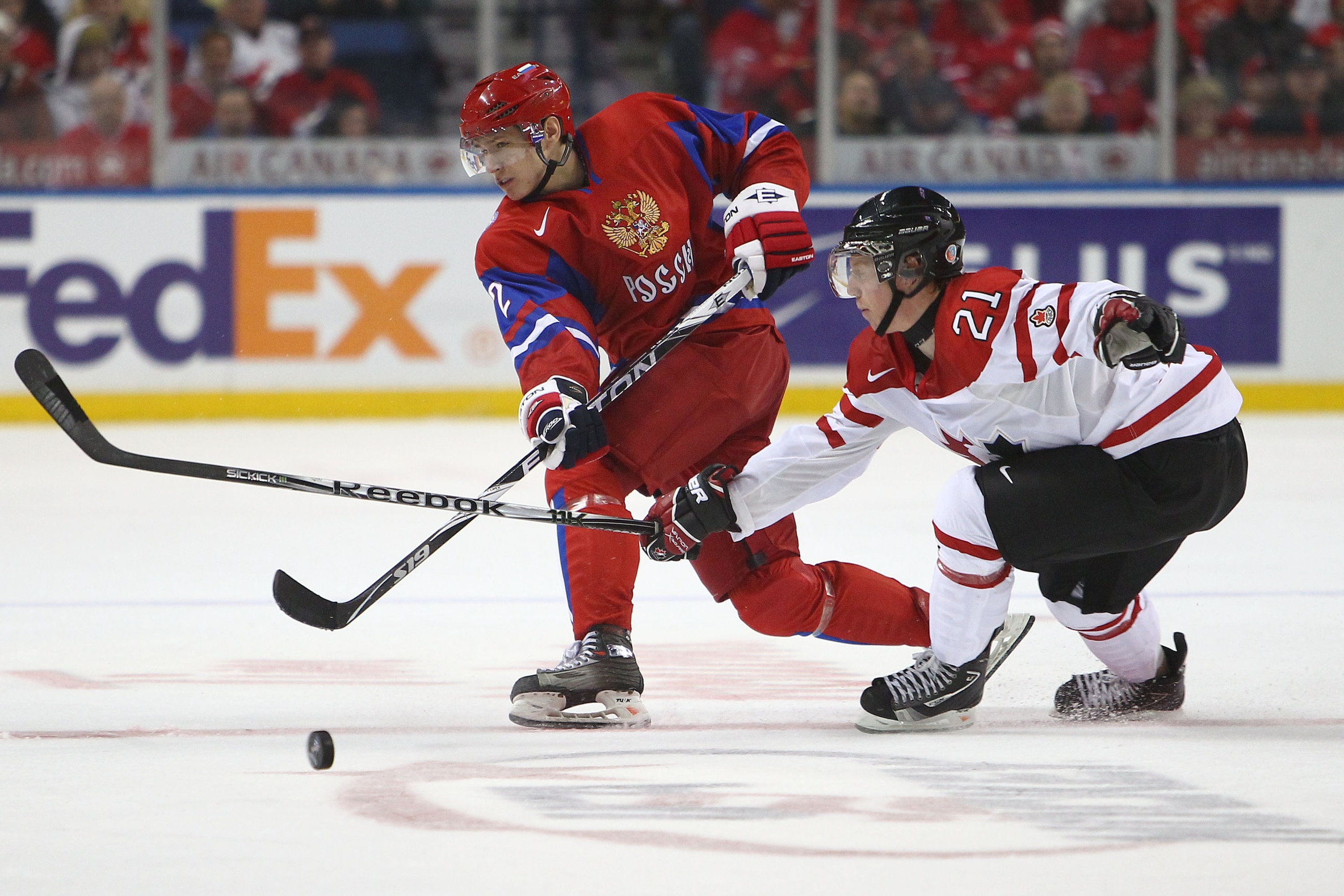 BUFFALO, NY - DECEMBER 26: Defenseman Nikita Zaitsev #2 of Russia dumps the puck in as forward Cody Eakin #21 of Canada tries to block the puck during the 2011 IIHF World U20 Championship Group B game between Canada and Russia on December 26, 2010 at HSBC BUFFALO, NY - DECEMBER 26: Defenseman Nikita Zaitsev #2 of Russia dumps the puck in as forward Cody Eakin #21 of Canada tries to block the puck during the 2011 IIHF World U20 Championship Group B game between Canada and Russia on December 26, 2010 at HSBC