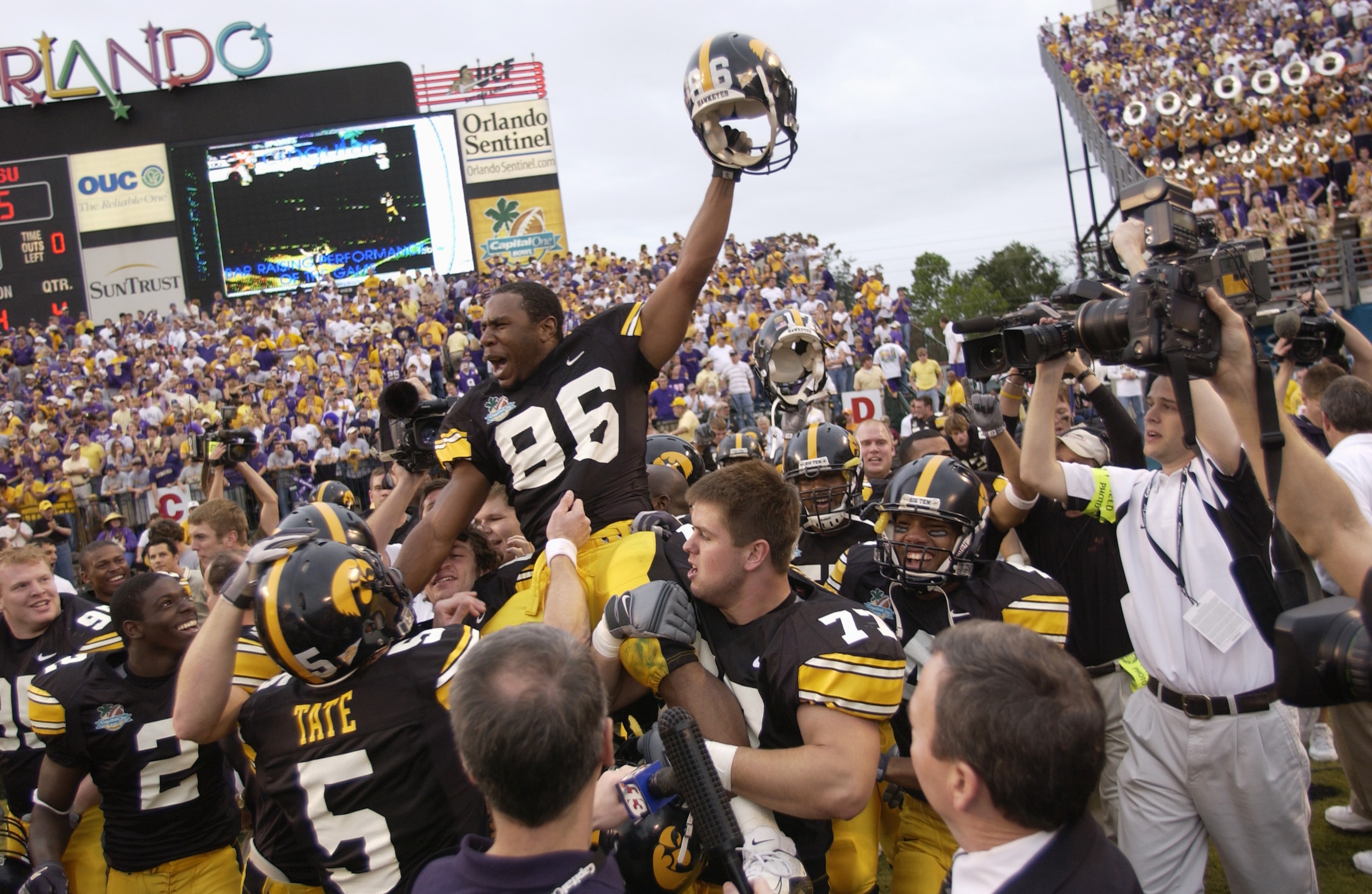 ORLANDO, FL - JANUARY 1: Warren Holloway #86 of the Iowa Hawkeyes is carried on the field by teammates following the Capital One Bowl game against the LSU Tigers at the Florida Citrus Bowl on January 1, 2005 in Orlando, Florida. The Hawkeyes won 30-25. ( ORLANDO, FL - JANUARY 1: Warren Holloway #86 of the Iowa Hawkeyes is carried on the field by teammates following the Capital One Bowl game against the LSU Tigers at the Florida Citrus Bowl on January 1, 2005 in Orlando, Florida. The Hawkeyes won 30-25. (
