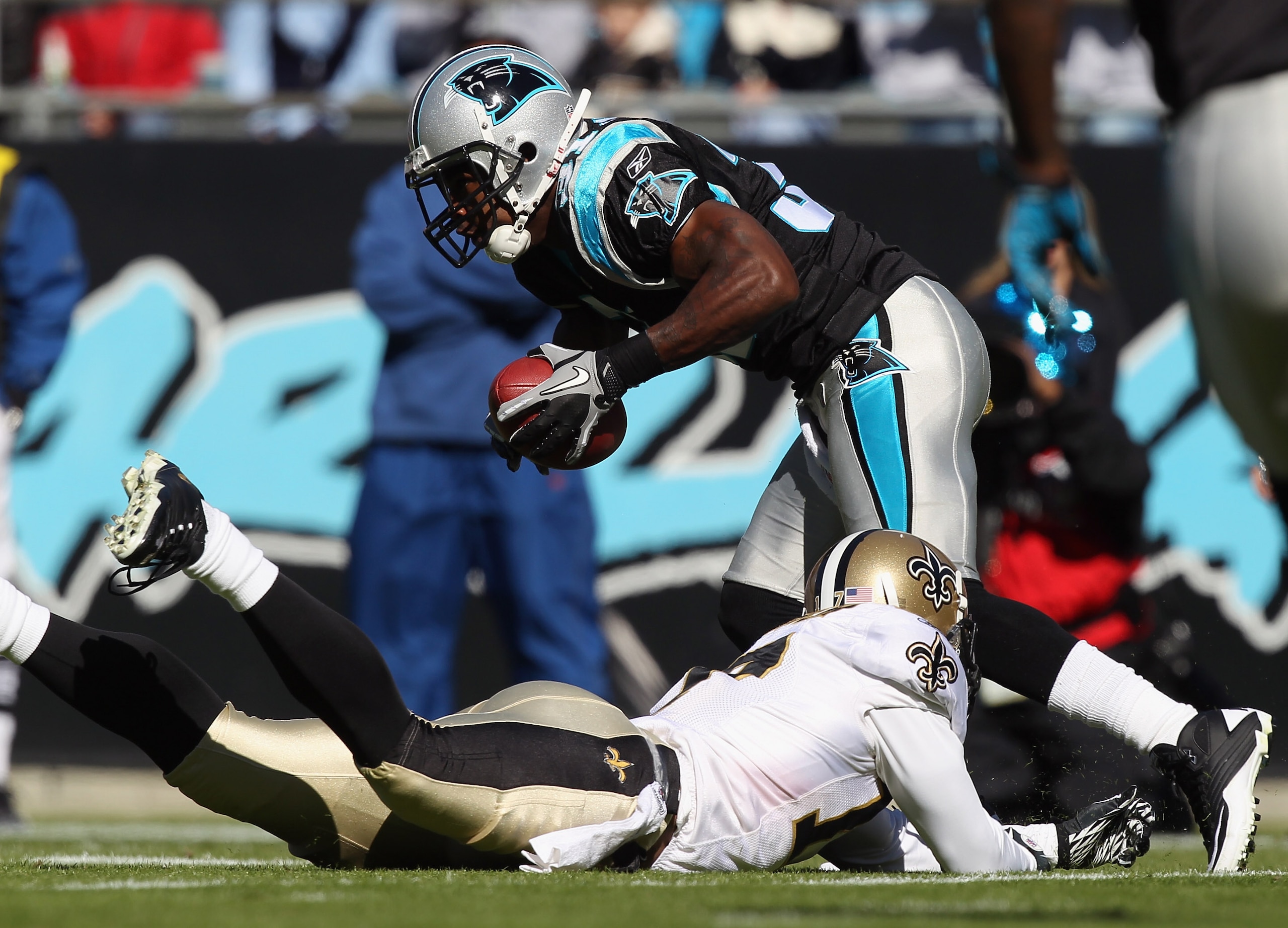 CHARLOTTE, NC - NOVEMBER 07:  Robert Meachem #17 of the New Orleans Saints tries to tackle Richard Marshall #31 of the Carolina Panthers after an interception during their game at Bank of America Stadium on November 7, 2010 in Charlotte, North Carolina.