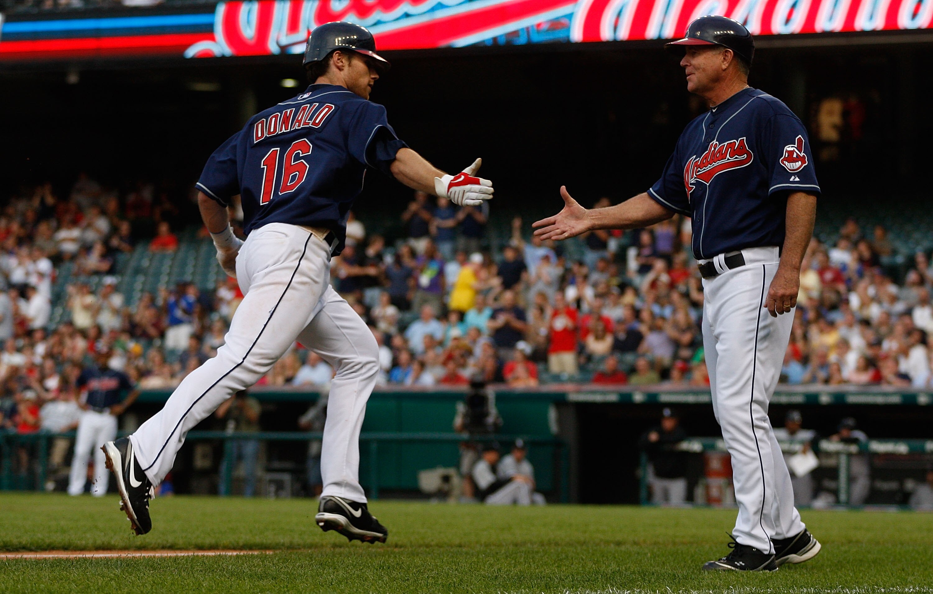 CLEVELAND - MAY 25:  Jason Donald #16 of the Cleveland Indians is congratulated while rounding third base by Steve Smith #10 after hitting a home run against the Chicago White Sox during the game on May 25, 2010 at Progressive Field in Cleveland, Ohio.  (