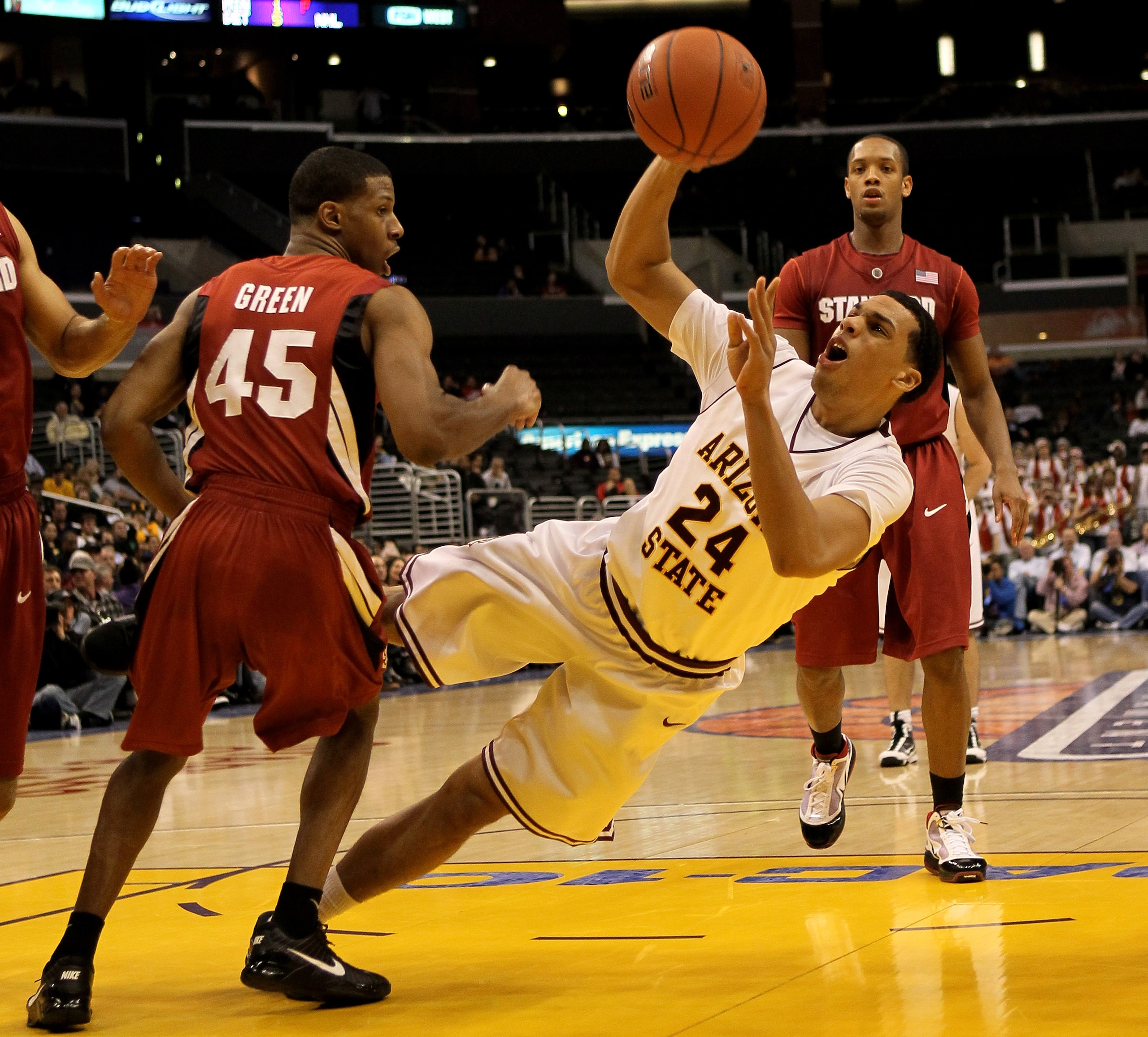 LOS ANGELES - MARCH 11: Trent Lockett #24 of the Arizona State Sun Devils tries to put up a shot as he falls to the court in front of Jeremy Green #45 of the Stanford Cardinal during the quarterfinals of the Pac-10 Basketball Tournament at Staples Center