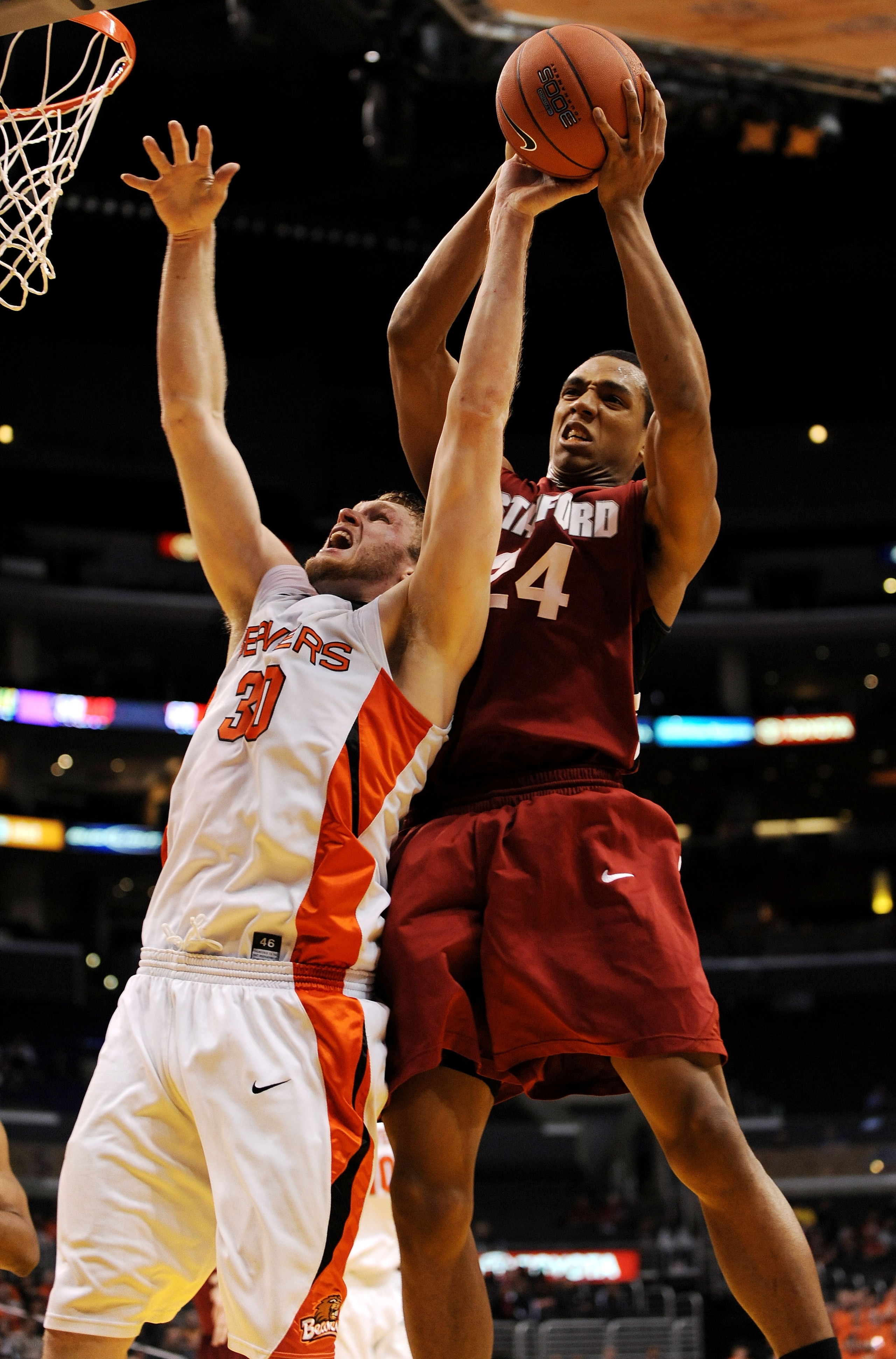 LOS ANGELES, CA - MARCH 11:  Forward Daniel Deane #30 of the Oregon State Beavers and center Josh Owens #24 of the Stanford Cardinal go up for a rebound during the Pacific Life Pac-10 Men's Basketball Tournament at the Staples Center on March 11, 2009 in