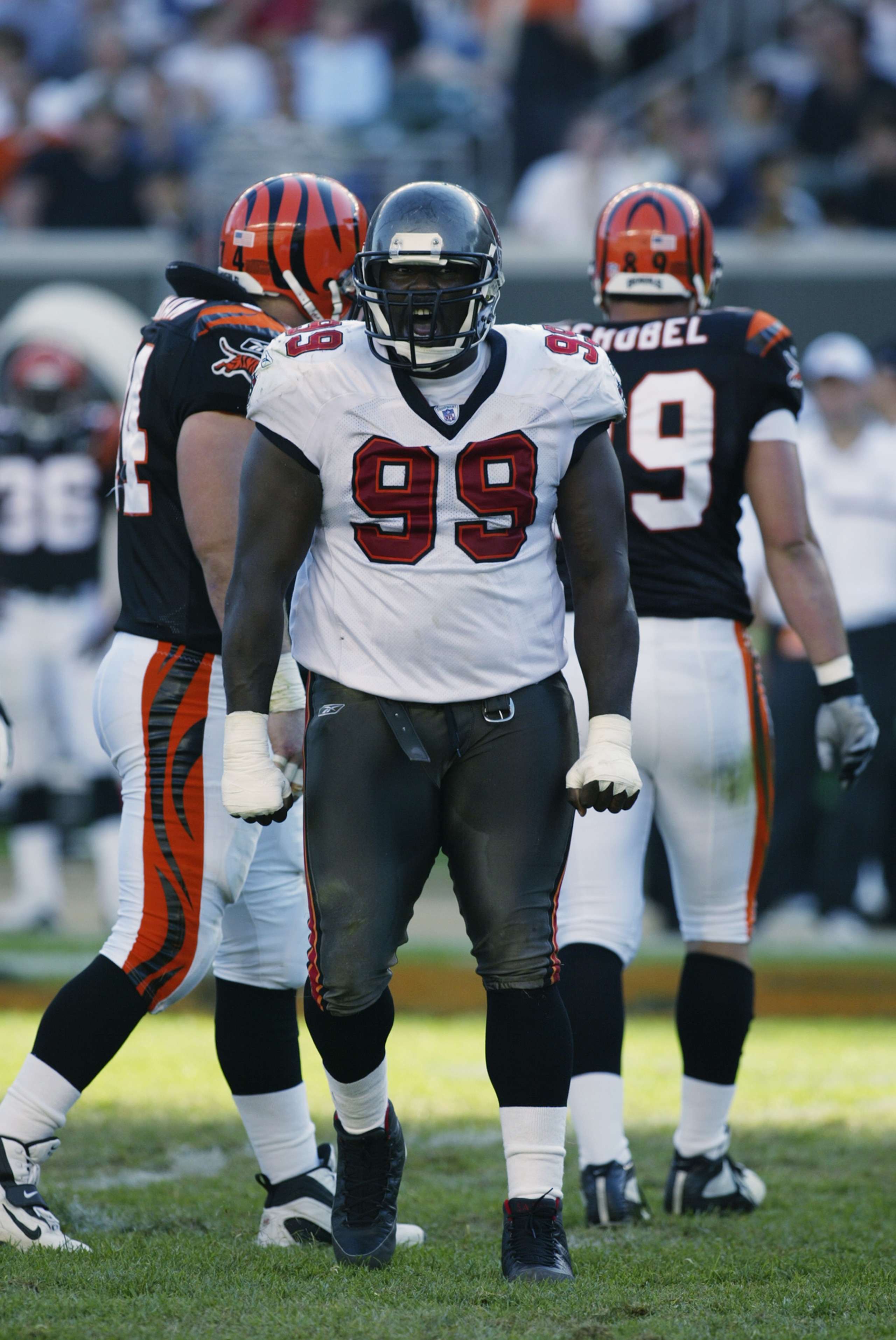 CINCINNATI - SEPTEMBER 29:   Defensive Lineman Warren Sapp #99 of the Tampa Bay Buccaneers celebrates after sacking Quarterback Akili Smith #11 of the Cincinnati Bengals during the first half on September 29, 2002 at Paul Brown Stadium in Cincinnati, Ohio
