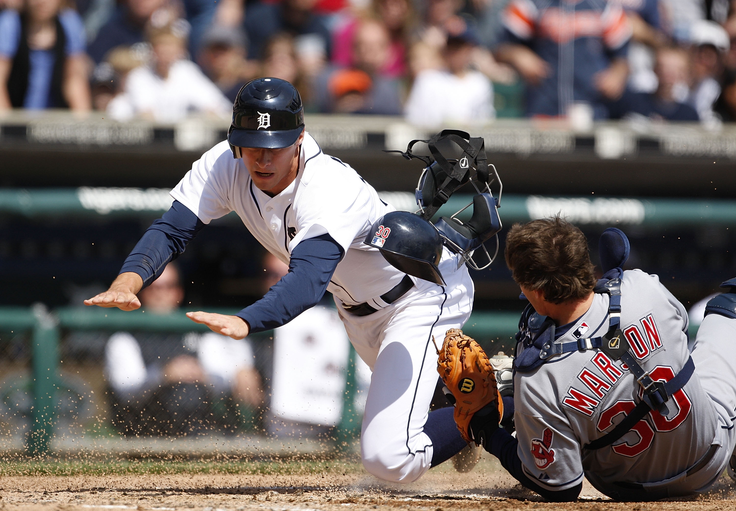 DETROIT - APRIL 11:  Lou Marson #30 of the Cleveland Indians tags out Don Kelly #32 of the Detroit Tigers at home plate in the third inning during the game on April 11, 2010 at Comerica Park in Detroit, Michigan.  (Photo by Leon Halip/Getty Images)