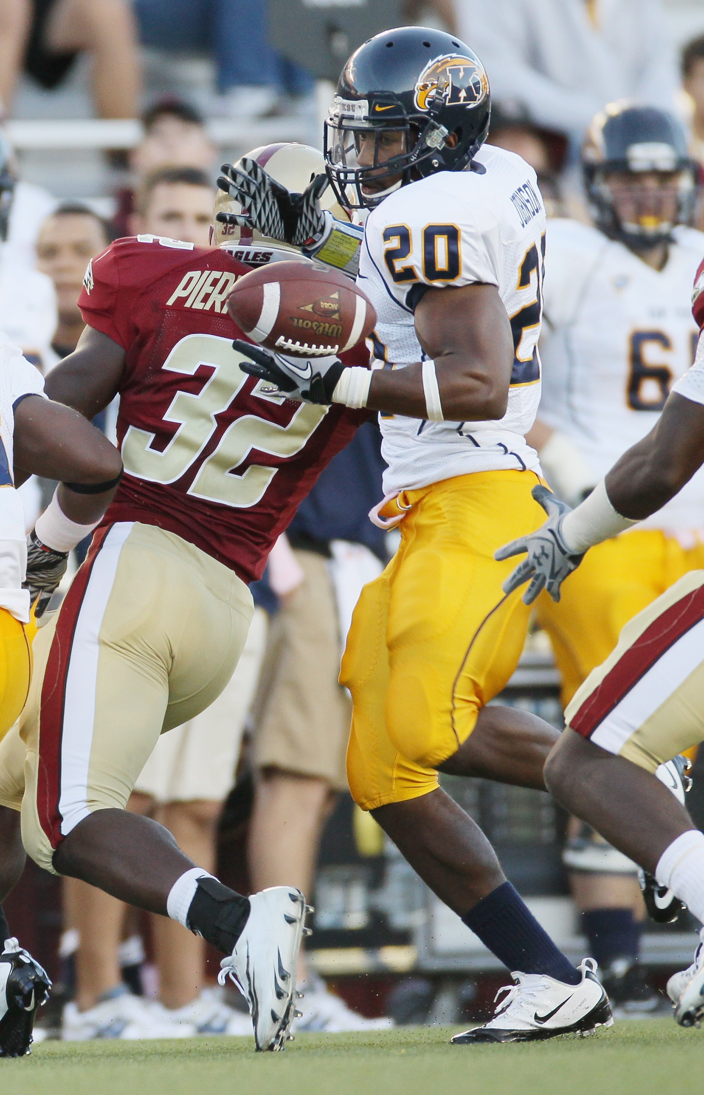 CHESTNUT HILL, MA - SEPTEMBER 11:  Will Johnson #20 of the Kent State Golden Flashes cannot hang on to teammate Leneric Muldrow's fumble as Kevin Pierre-Lewis #32 of the Boston College Eagles defends on September 11, 2010 at Alumni Stadium in Chestnut Hil