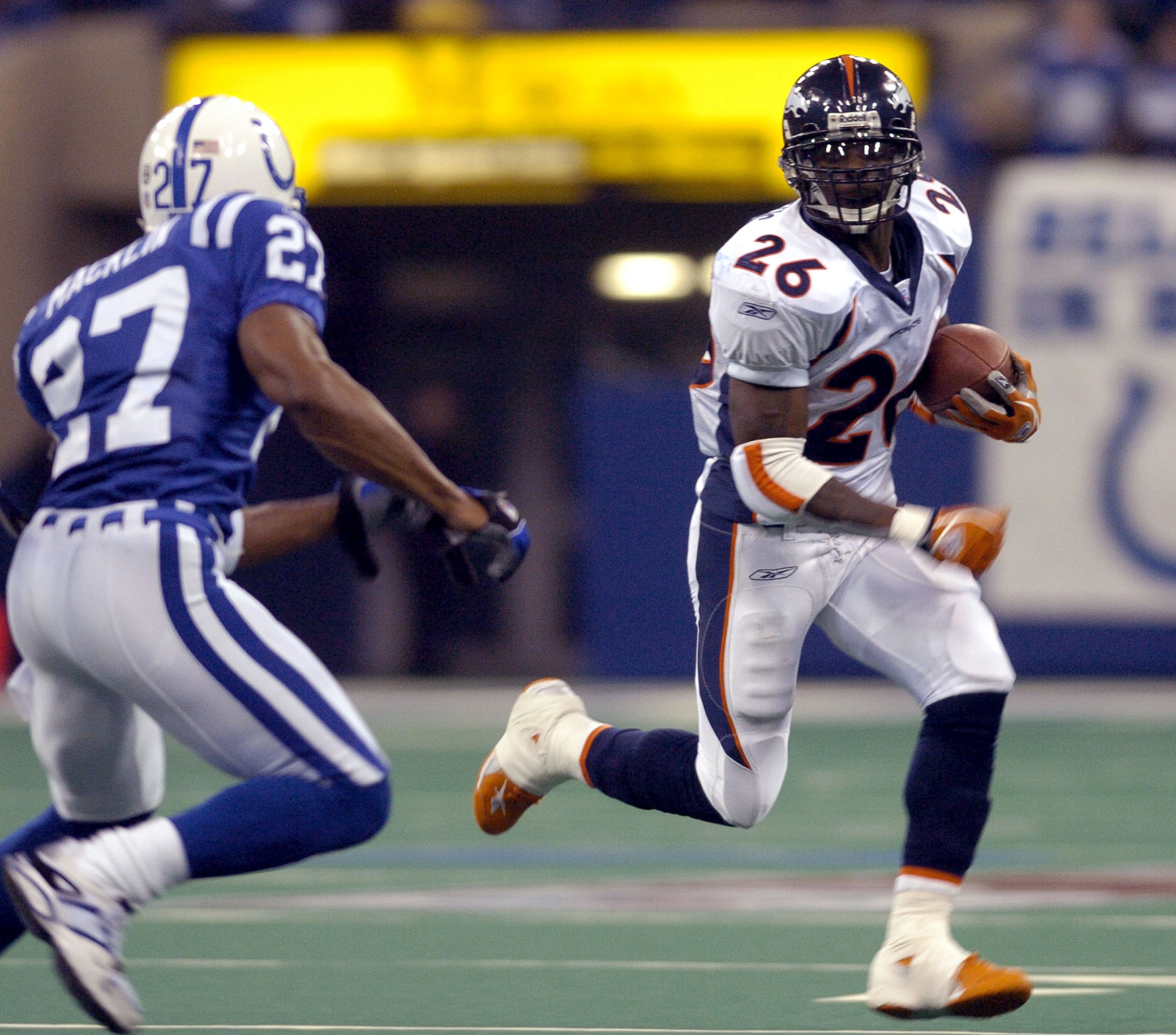 Denver Broncos running back Clinton Portis rushes for a gain at the RCA Dome, Indianapolis, Indiana, January 4, 2004 in an AFC wildcard playoff game.  (Photo by Al Messerschmidt/Getty Images)