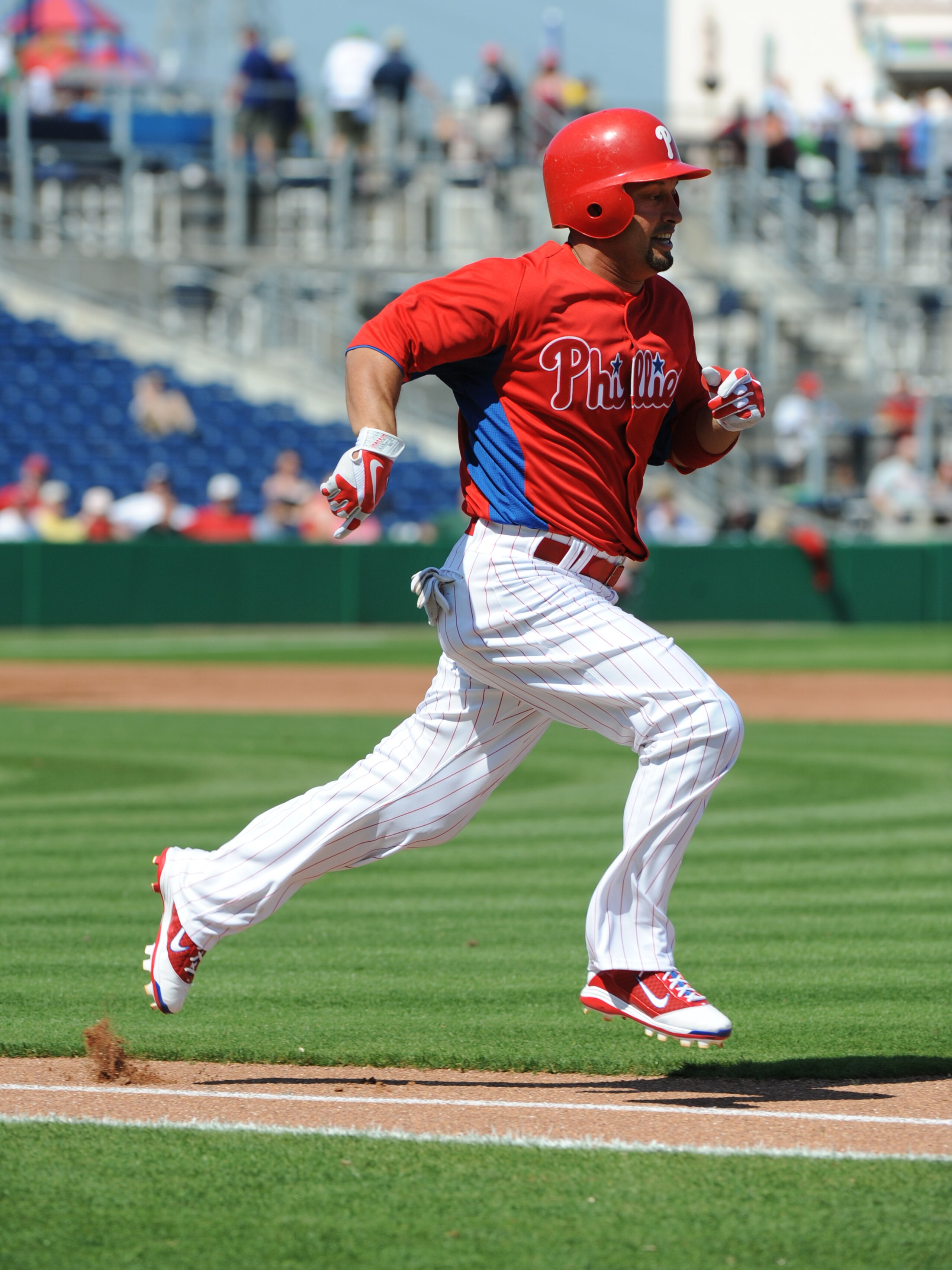 CLEARWATER, FL - FEBRUARY 24:  Outfielder Shane Victorino #8 of the Philadelphia Phillies runs at first base against the Florida State Seminoles February 24, 2011 at Bright House Field in Clearwater, Florida.  (Photo by Al Messerschmidt/Getty Images)