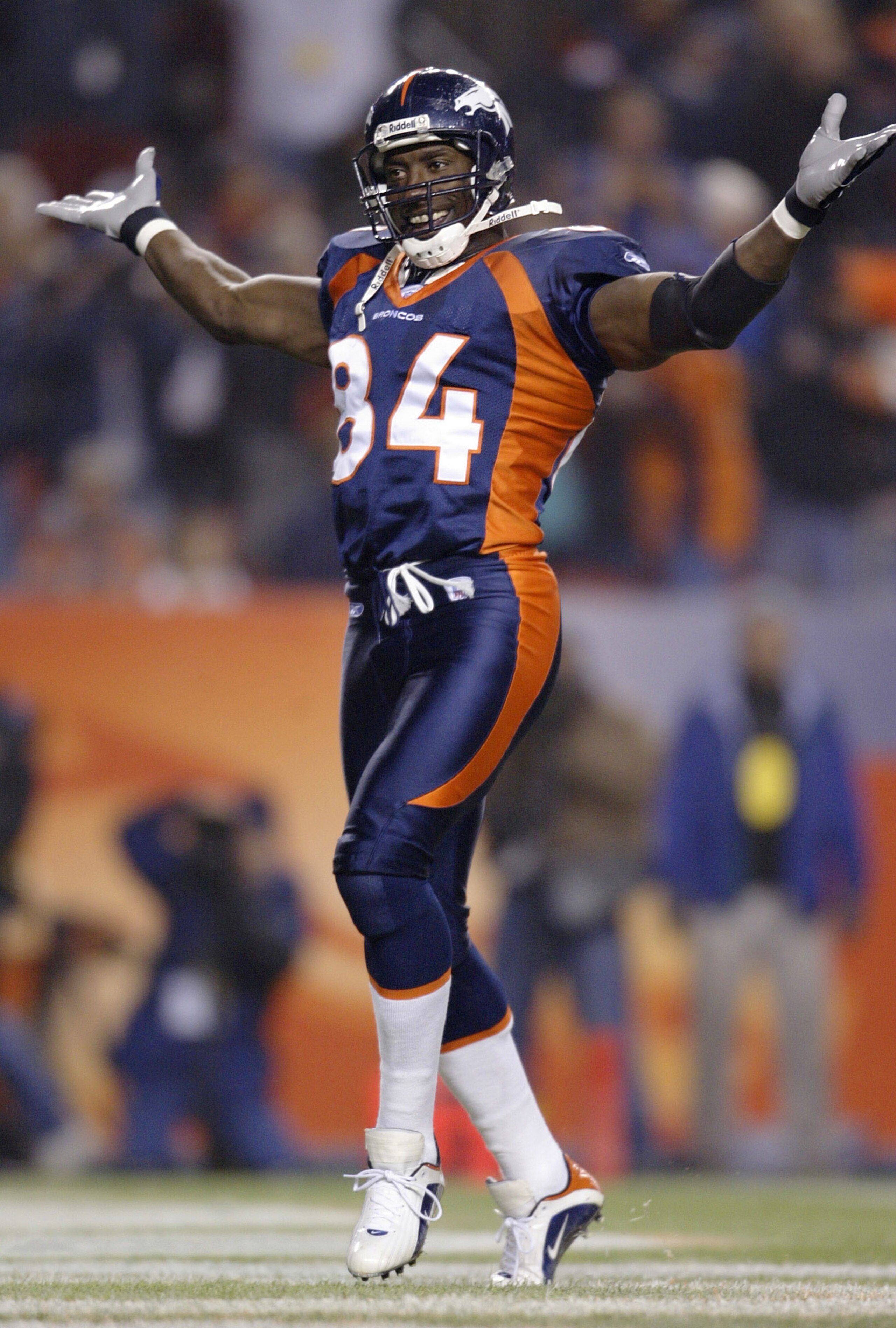 DENVER - NOVEMBER 3:  Tight end Shannon Sharpe #84 of the Denver Broncos celebrates a touchdown by running back Clinton Portis against the New England Patriots in the first quarter November 3, 2003 at Invesco Field at Mile High in Denver, Colorado.  (Phot