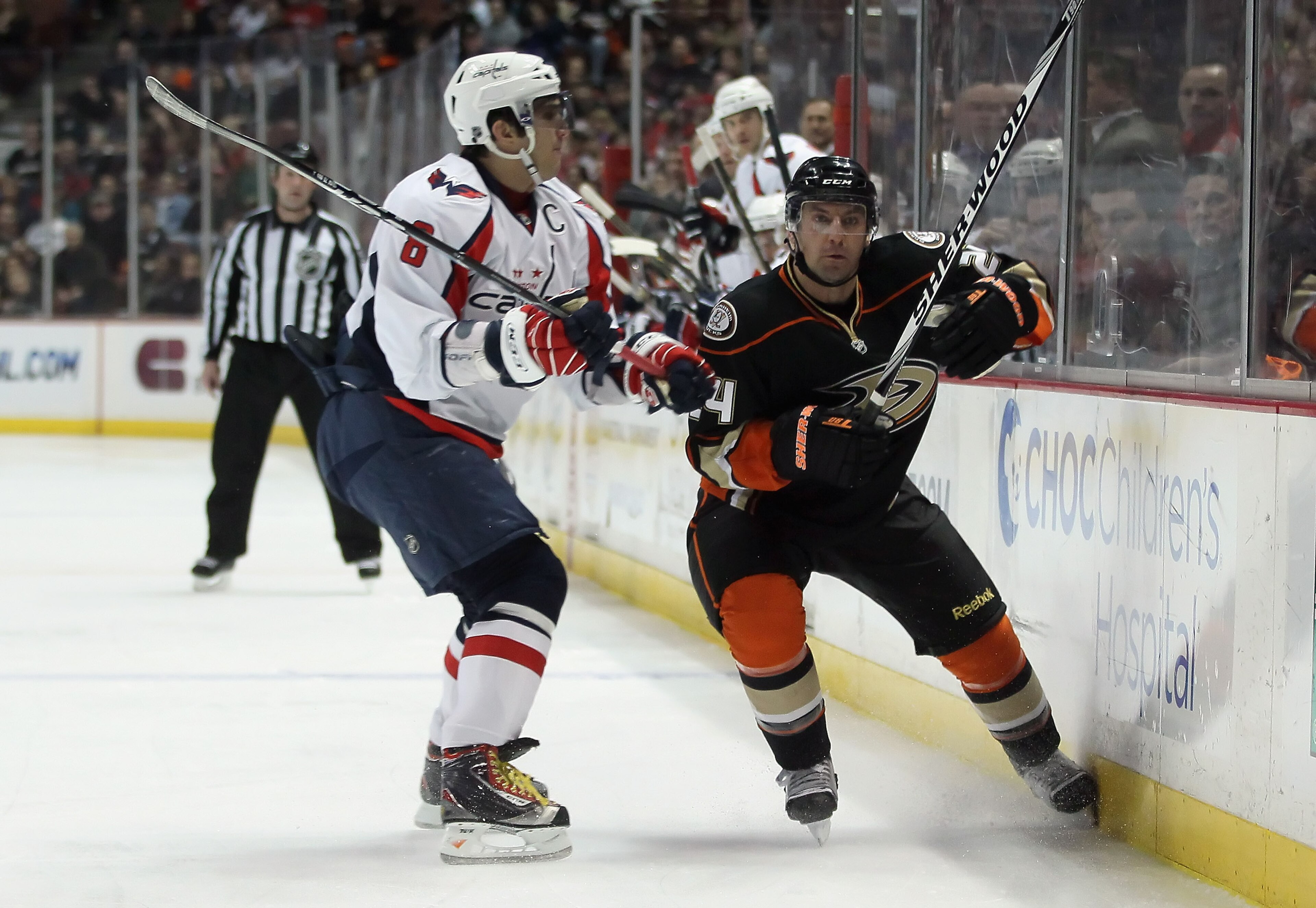 ANAHEIM, CA - FEBRUARY 16:  Alex Ovechkin #8 of the Washington Capitals checks Francois Beauchemin #24 of the Anaheim Ducks into the boards in the first period at the Honda Center on February 16, 2011 in Anaheim, California. The Capitals defeated the Duck