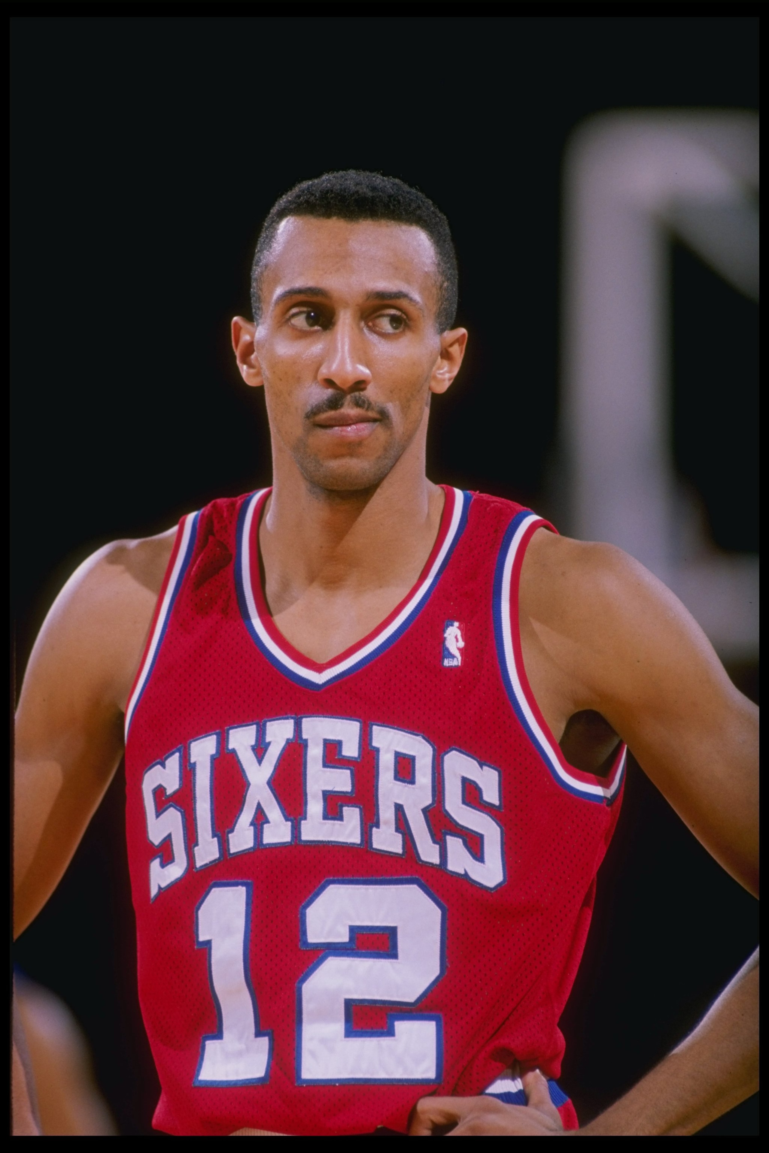 Guard Johnny Dawkins of the Philadelphia 76ers looks on.