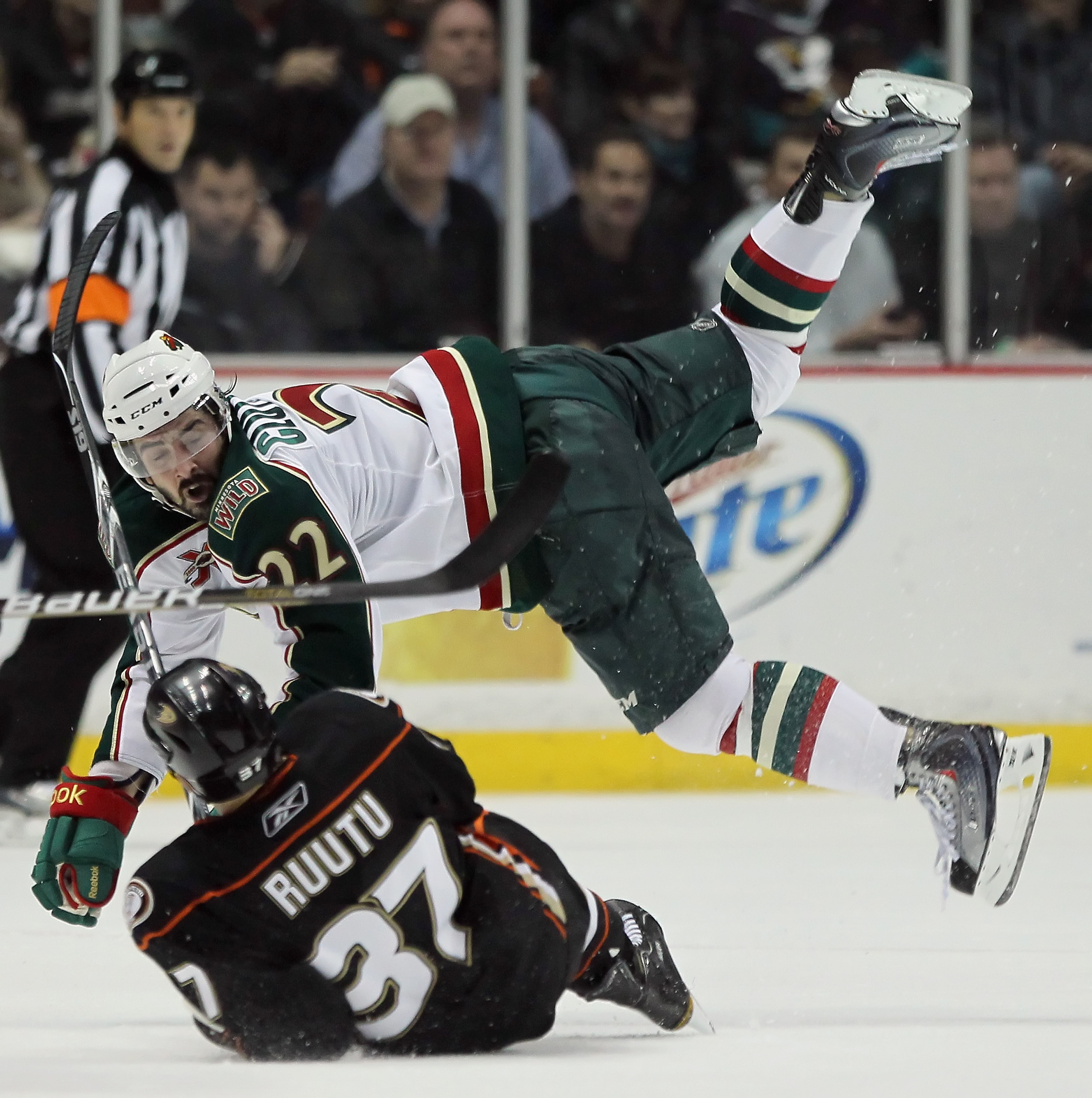ANAHEIM, CA - FEBRUARY 25:  Cal Clutterbuck #22 of the Minnesota Wild hits Jarkko Ruutu #37 of the Anaheim Ducks in the third period at Honda Center on February 25, 2011 in Anaheim, California. The Wild defeated the Ducks 3-2 in overtime.  (Photo by Jeff