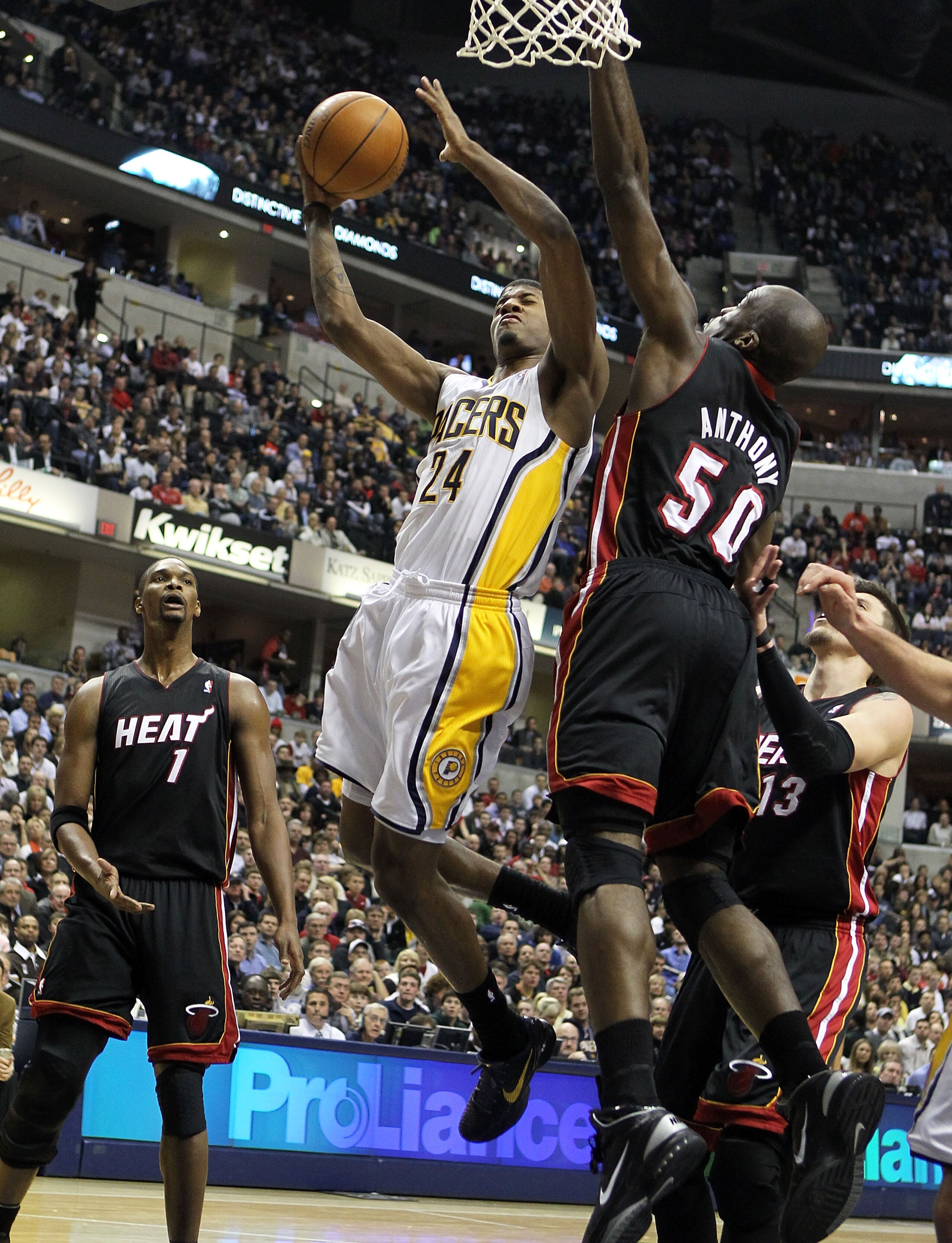 INDIANAPOLIS - FEBRUARY 15: Joel Anthony #50 of the Miami Heat defends the shot of Paul George #24 of the Indiana Pacers during the NBA game at Conseco Fieldhouse on February 15, 2011 in Indianapolis, Indiana. The Heat won 110-103. NOTE TO USER: User INDIANAPOLIS - FEBRUARY 15: Joel Anthony #50 of the Miami Heat defends the shot of Paul George #24 of the Indiana Pacers during the NBA game at Conseco Fieldhouse on February 15, 2011 in Indianapolis, Indiana. The Heat won 110-103. NOTE TO USER: User