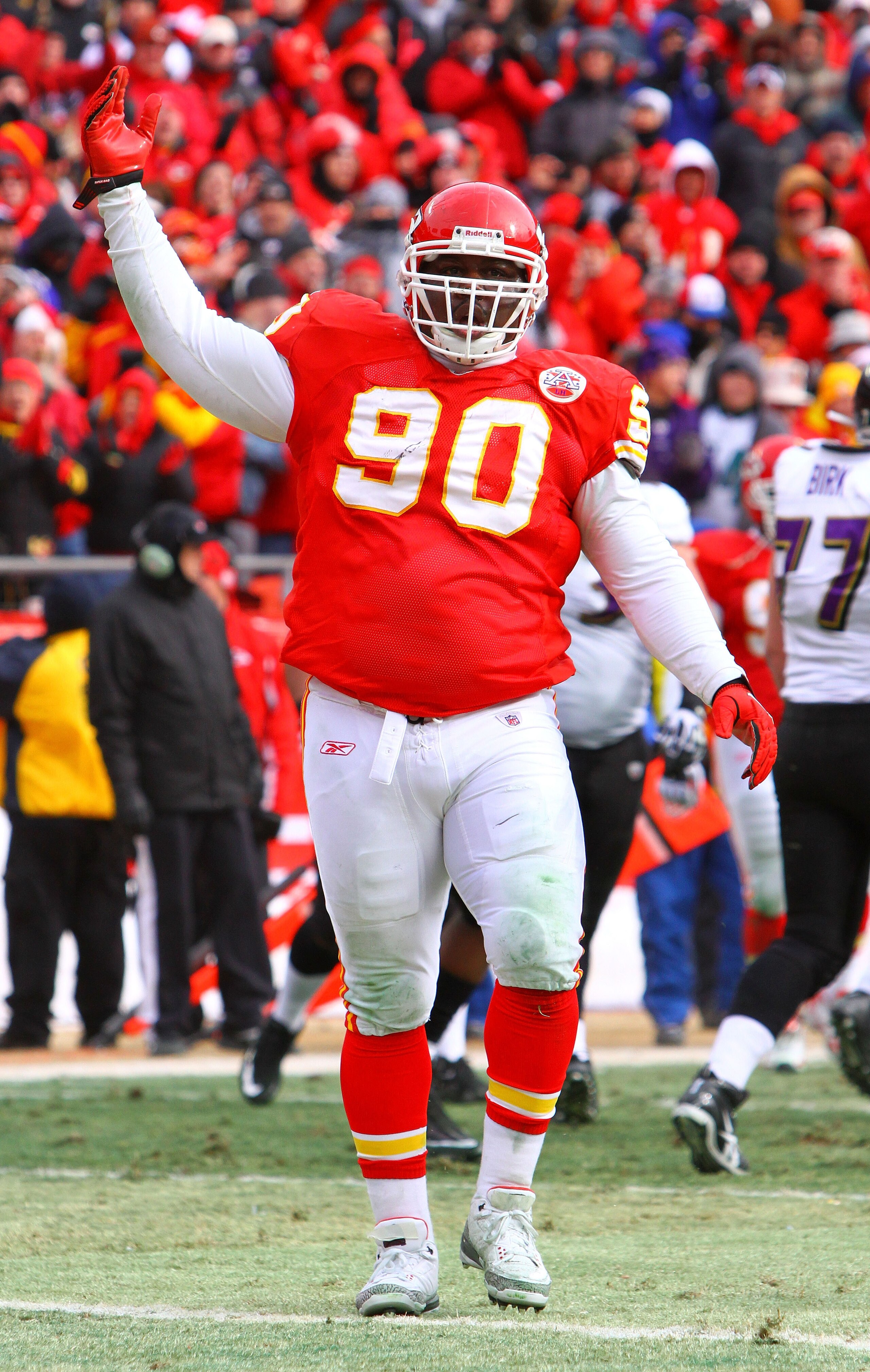 KANSAS CITY, MO - JANUARY 09:  Defensive tackle Shaun Smith #90 of the Kansas City Chiefs reacts against the Baltimore Ravens in the 2011 AFC wild card playoff game at Arrowhead Stadium on January 9, 2011 in Kansas City, Missouri.  (Photo by Dilip Vishwan