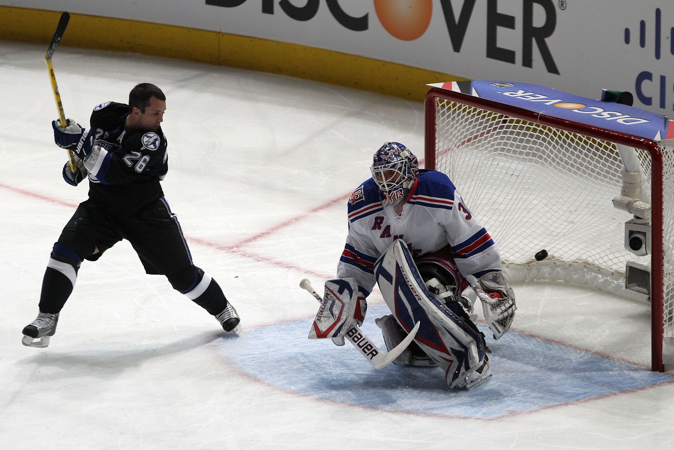 RALEIGH, NC - JANUARY 29:  Martin St. Louis #26 of the Tampa Bay Lightning shoots against Henrik Lundqvist #30 of New York Rangers during the elimination shootout part of the Honda NHL SuperSkills competition part of 2011 NHL All-Star Weekend at the RBC C