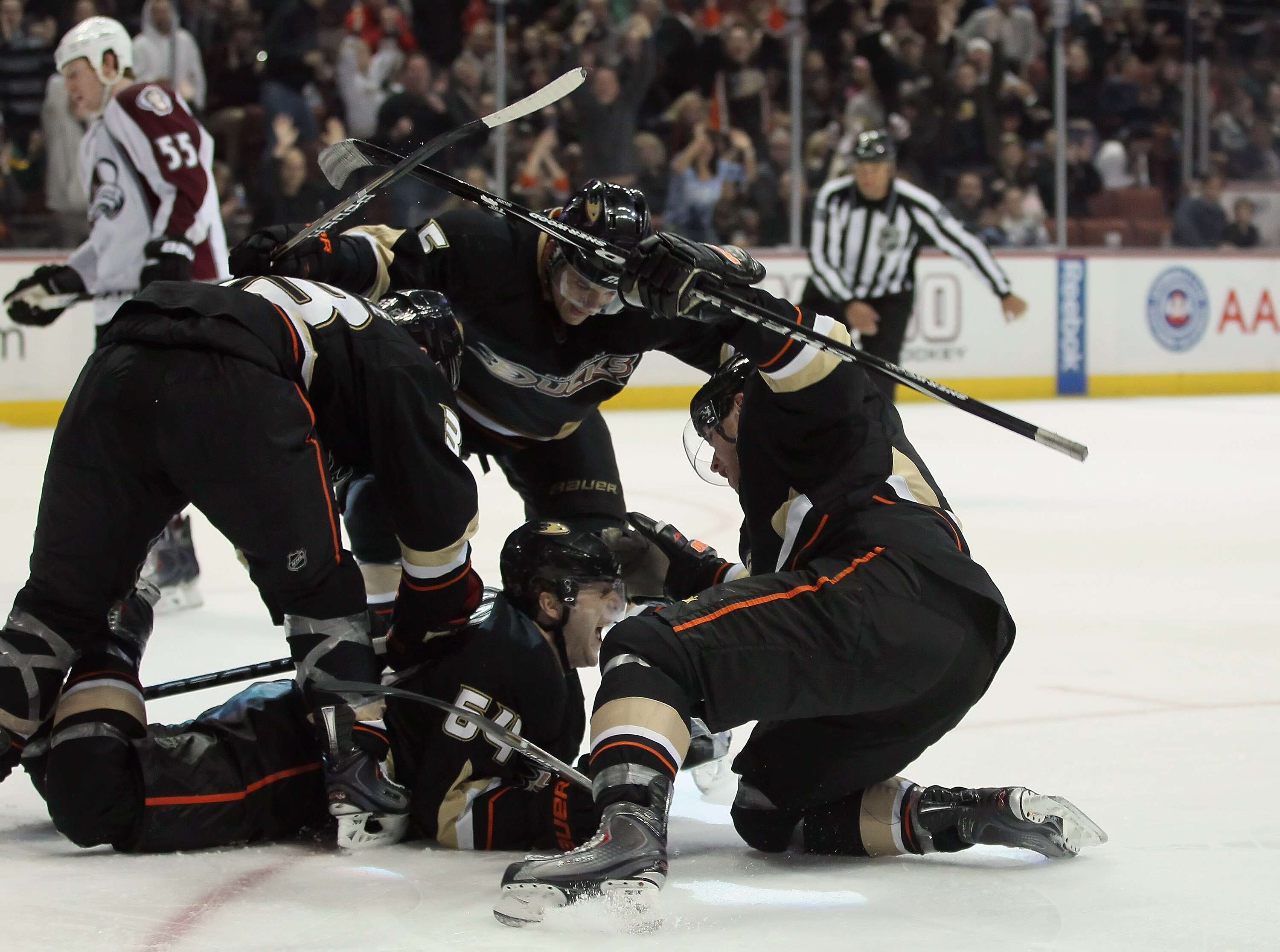 ANAHEIM, CA - FEBRUARY 27:  (clockwise from top) Luca Sbisa #5, Bobby Ryan #9, Brandon McMillan #64 and Jason Blake #33 of the Anaheim Ducks celebrate McMillan's go ahead goal in the third period against the Colorado Avalanche at Honda Center on February