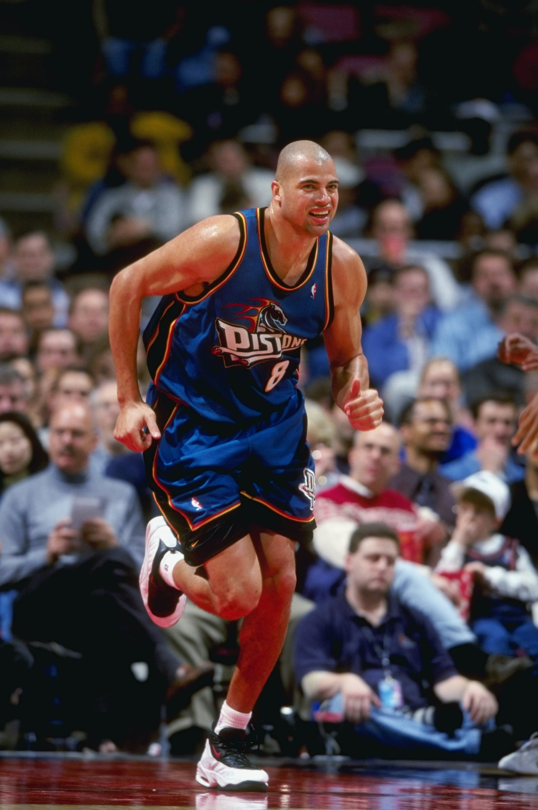 24 Mar 1999: Bison Dele #8 of the Detroit Pistons smiles as he runs down the court during a game against the New Jersey Nets at the Continental Airlines Arena in East Rutherford, New Jersey. The Piston defeated the Nets 84-71.