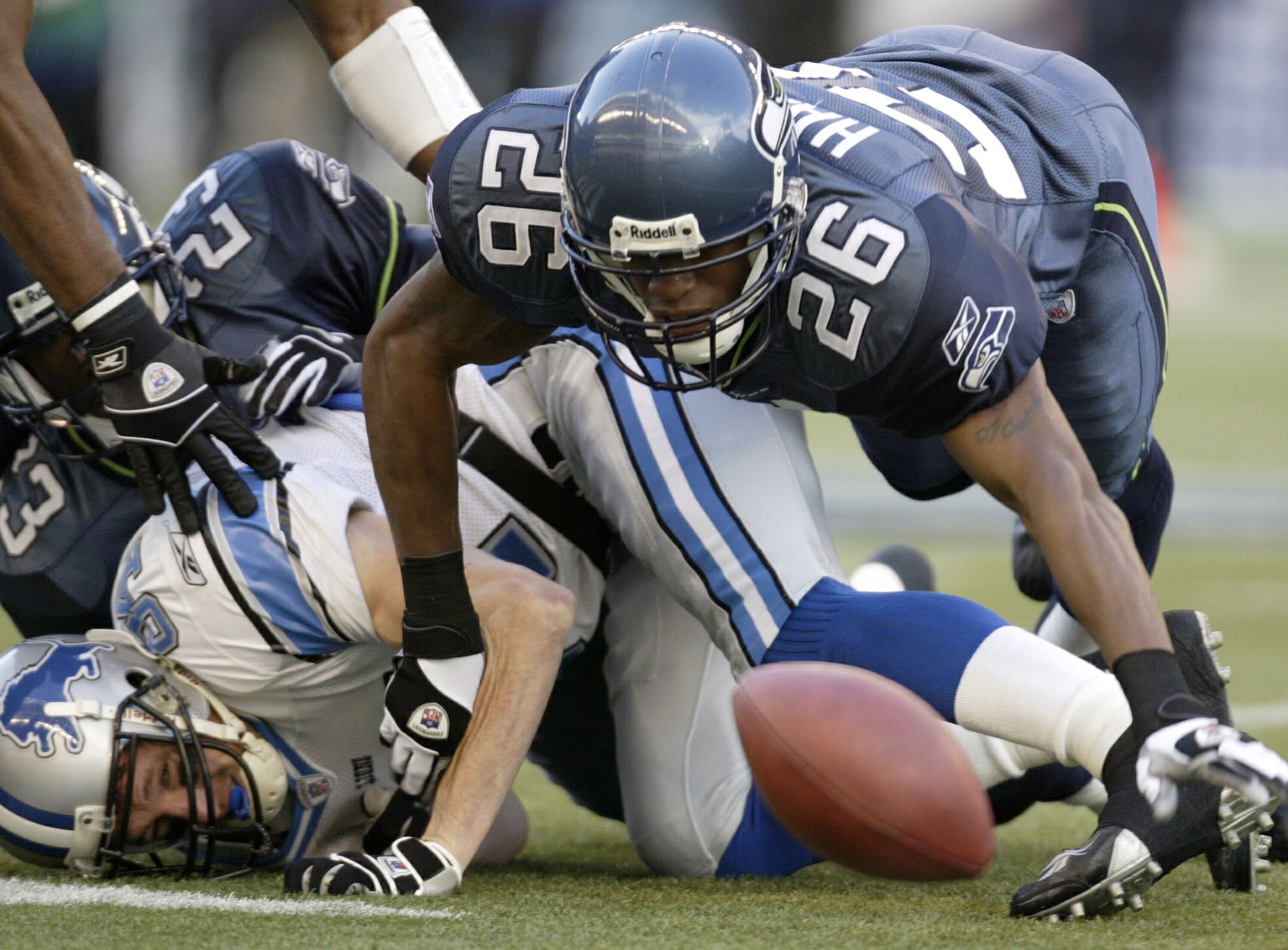 SEATTLE - NOVEMBER 16:  Wide Receiver Bill Schroeder #84 of the Detroit Lions fumbles against Ken Hamlin #26 of the Seattle Seahawks on November 16, 2003 at Seahawks Stadium in Seattle, Washington. The Lions recovered the ball.  (Photo by Otto Greule Jr/G