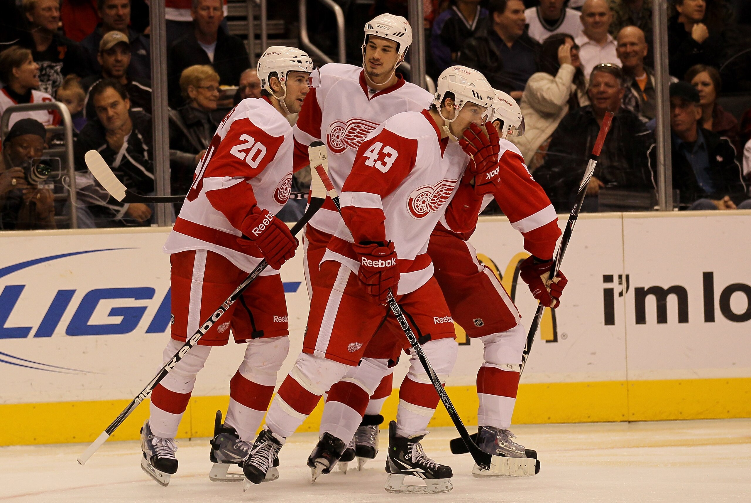 LOS ANGELES, CA - FEBRUARY 28: Drew Miller #20 of the Detroit Red Wings celebrates his third pereiod goal with Jonathan Ericsson #52 (C) and Darren Helm #43 against the Los Angeles Kings at Staples Center on February 28, 2011 in Los Angeles, California.