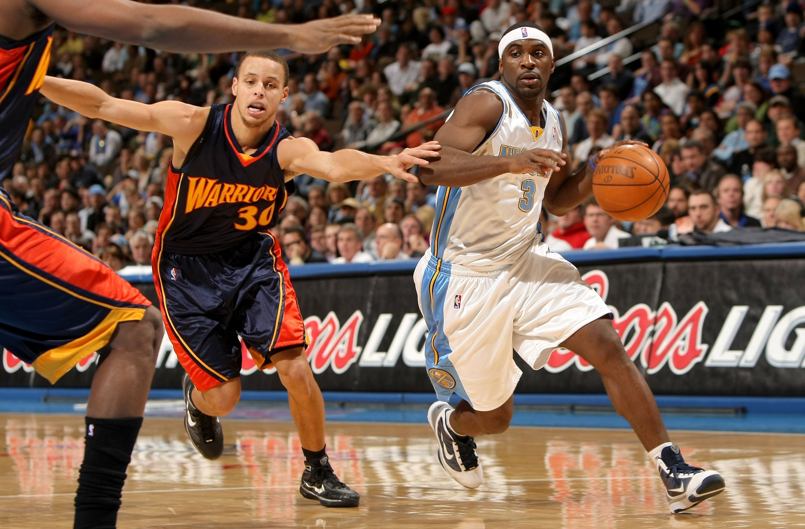 DENVER - JANUARY 05: Ty Lawson #3 of the Denver Nuggets drives the ball around Stephen Curry #30 of the Golden State Warriors at the Pepsi Center on January 5, 2010 in Denver, Colorado. The Nuggets defeated the Warriors 123-122. NOTE TO USER: User expres DENVER - JANUARY 05: Ty Lawson #3 of the Denver Nuggets drives the ball around Stephen Curry #30 of the Golden State Warriors at the Pepsi Center on January 5, 2010 in Denver, Colorado. The Nuggets defeated the Warriors 123-122. NOTE TO USER: User expres