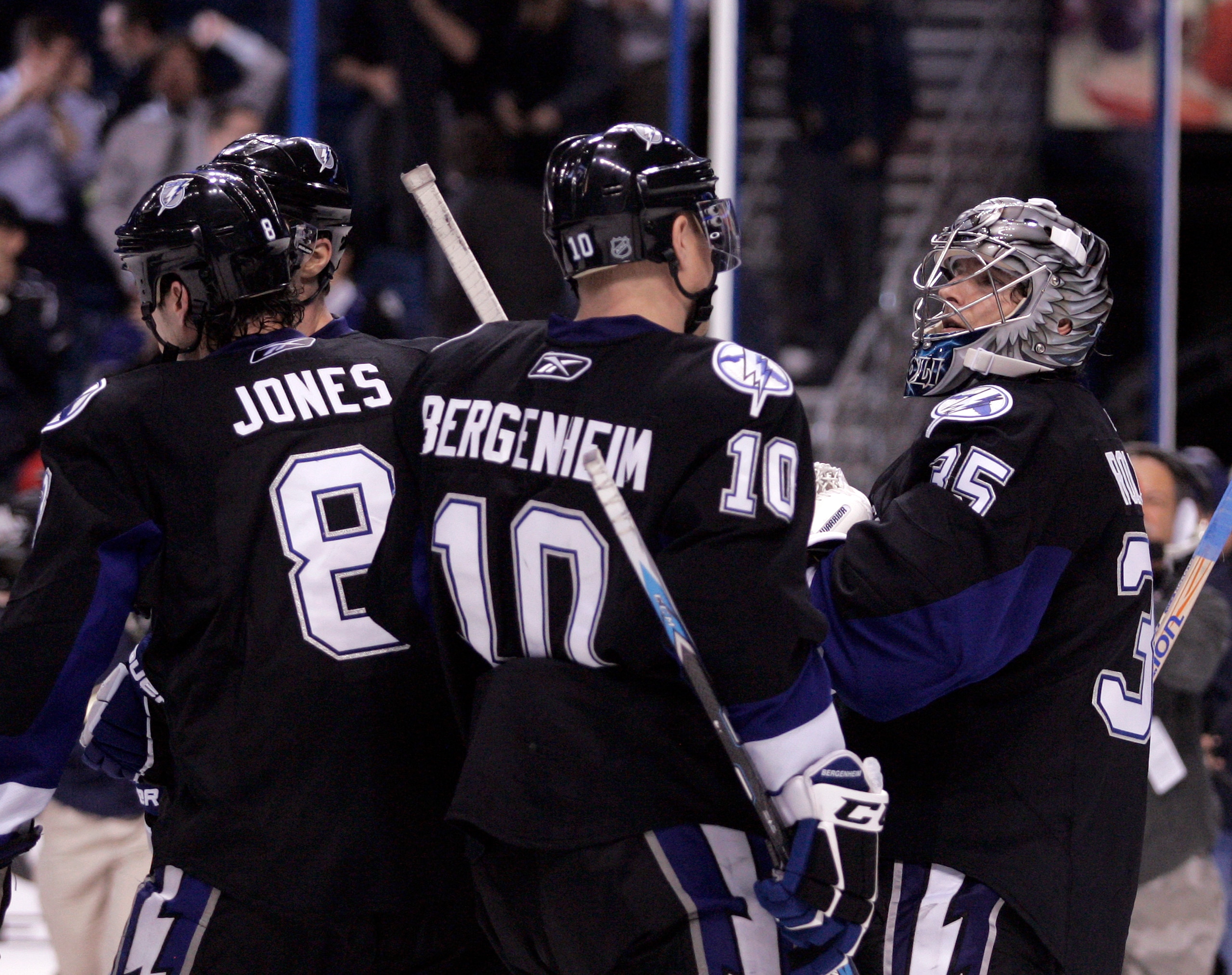TAMPA, FL - JANUARY 25:  Dwayne Roloson #35 of the Tampa Bay Lightning is congratulated by teammate Sean Bergenheim #10 after shutting out the Toronto Maple Leafs at St. Pete Times Forum on January 25, 2011 in Tampa, Florida.  The Lightning defeated the L