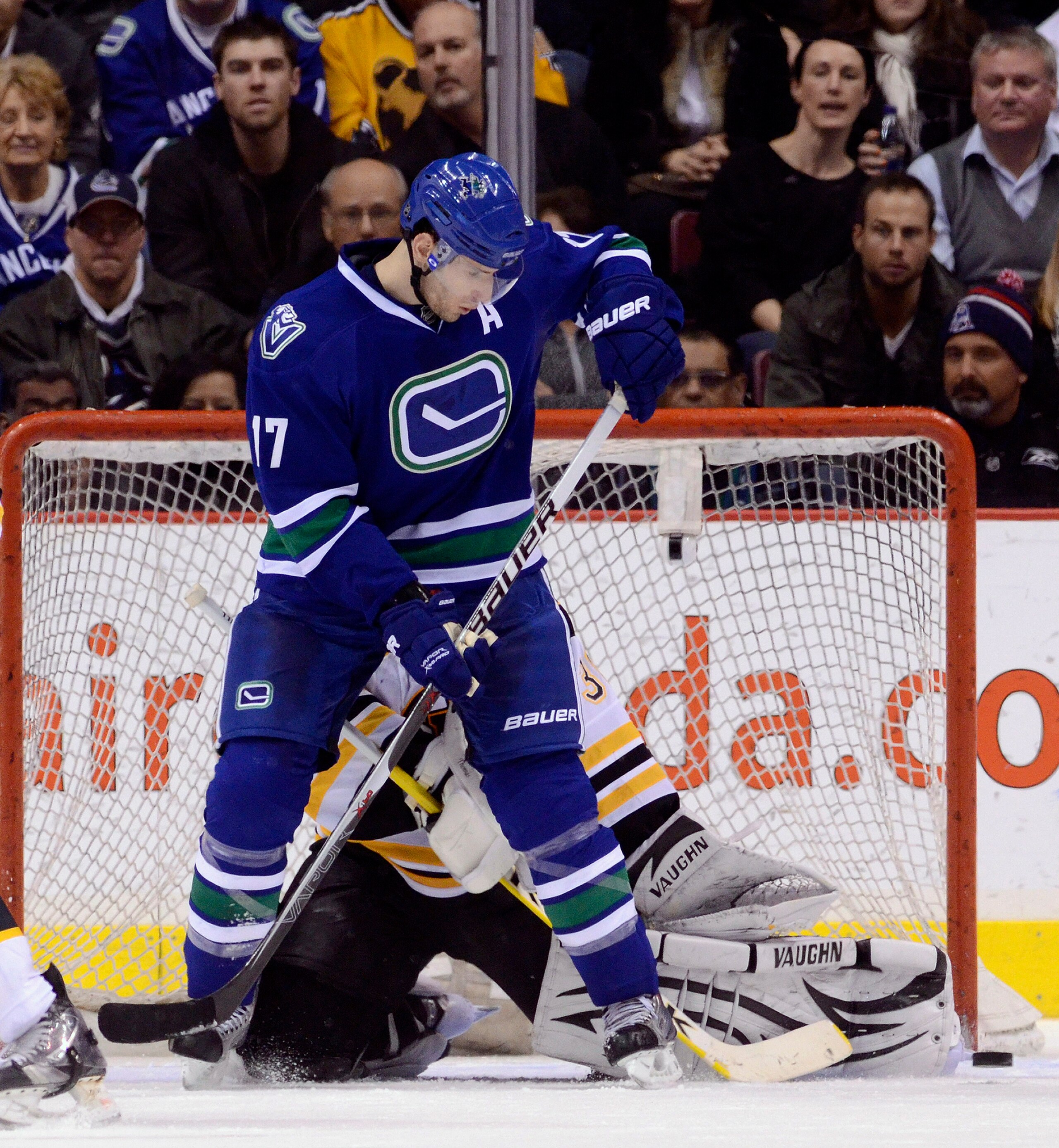 VANCOUVER, CANADA - FEBRUARY 26: Ryan Kesler #17 of the Vancouver Canucks deflects the puck wide of goalie Tim Thomas #30 of the Boston Bruins during the third period in NHL action on February 26, 2011 at Rogers Arena in Vancouver, British Columbia, Canad