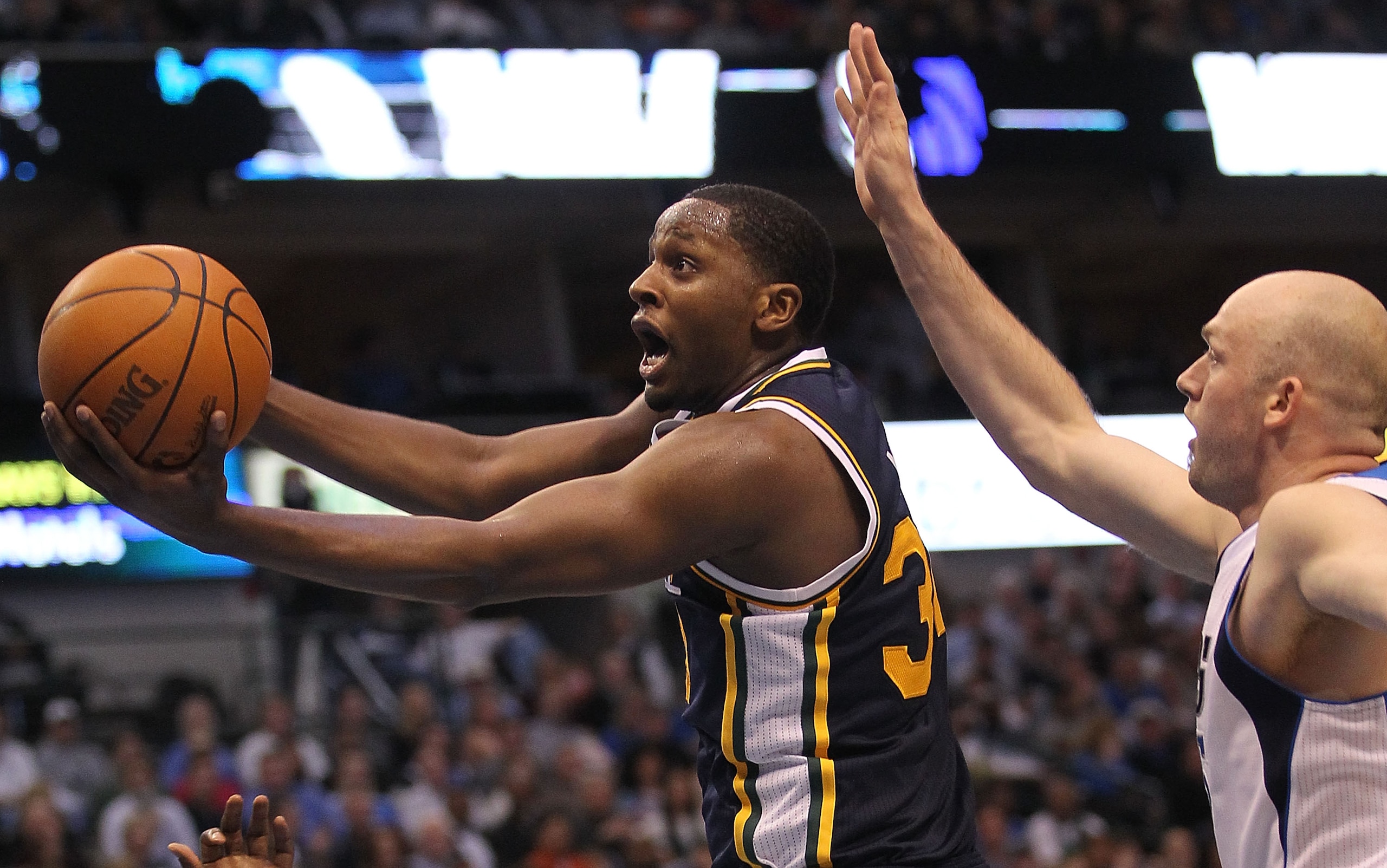 DALLAS, TX - FEBRUARY 23:  Forward C.J. Miles #34 of the Utah Jazz takes a shot against Brian Cardinal #35 of the Dallas Mavericks at American Airlines Center on February 23, 2011 in Dallas, Texas.  NOTE TO USER: User expressly acknowledges and agrees tha
