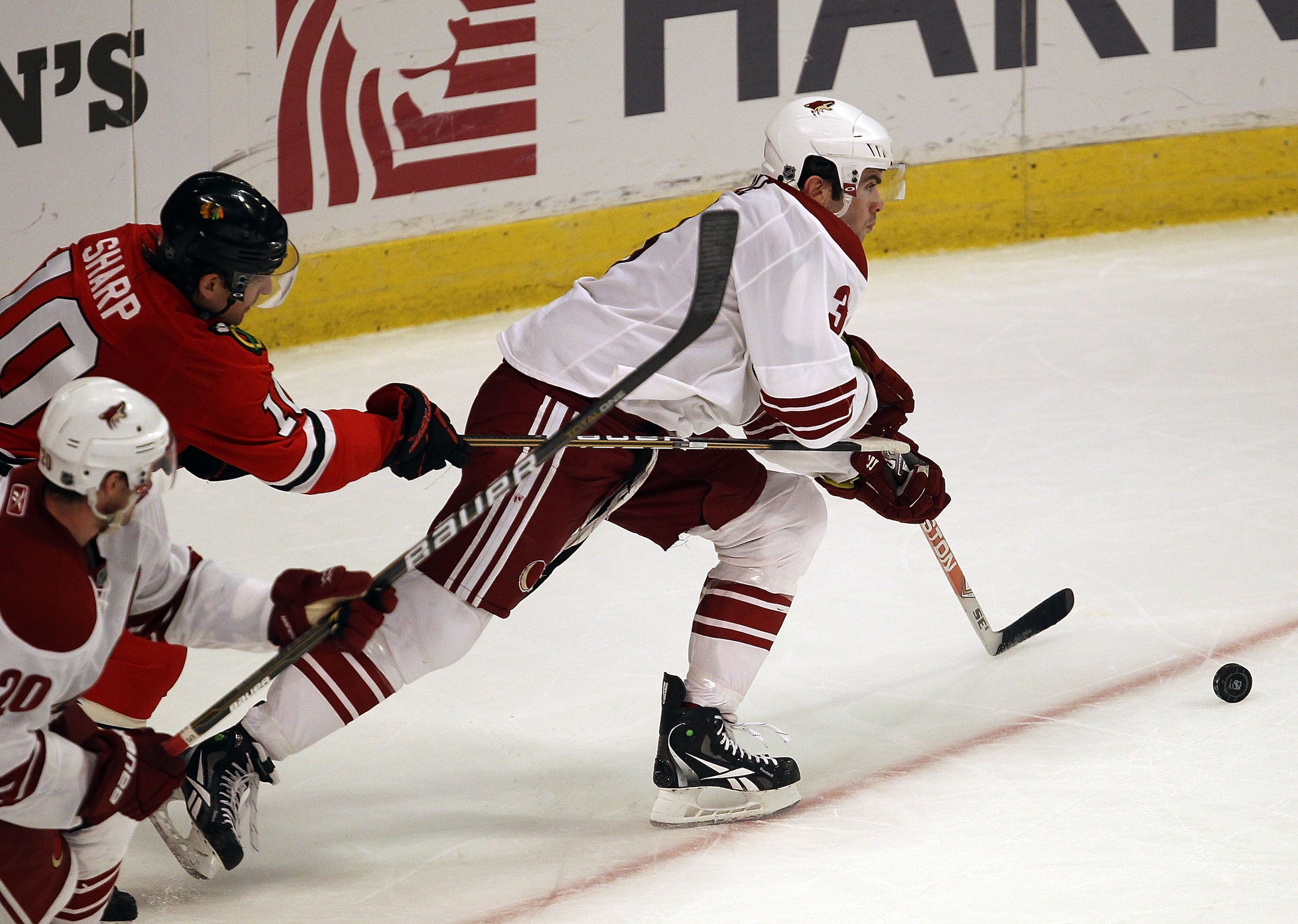CHICAGO, IL - FEBRUARY 27: Patrick Sharp #10 of the Chicago Blackhawks tries to slow Keith Yandle #3 of the Phoenix Coyotes at the United Center on February 27, 2011 in Chicago, Illinois. The Blackhawks defeated the Coyotes 4-3 in a shootout. (Photo by Jo