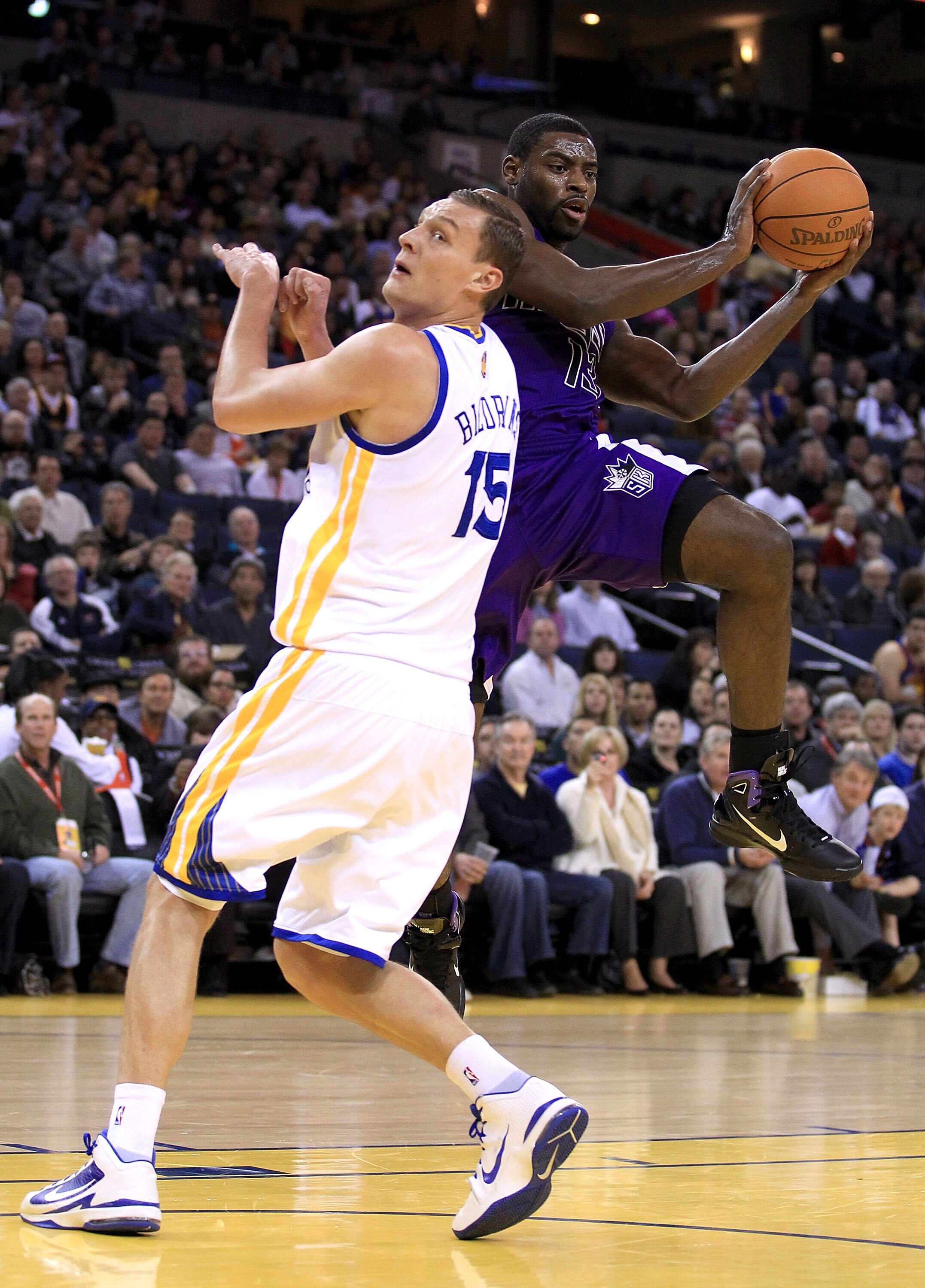 OAKLAND, CA - JANUARY 21:  Tyreke Evans #13 of the Sacramento Kings looks to pass around Andris Biedrins #15 of the Golden State Warriors at Oracle Arena on January 21, 2011 in Oakland, California. NOTE TO USER: User expressly acknowledges and agrees that