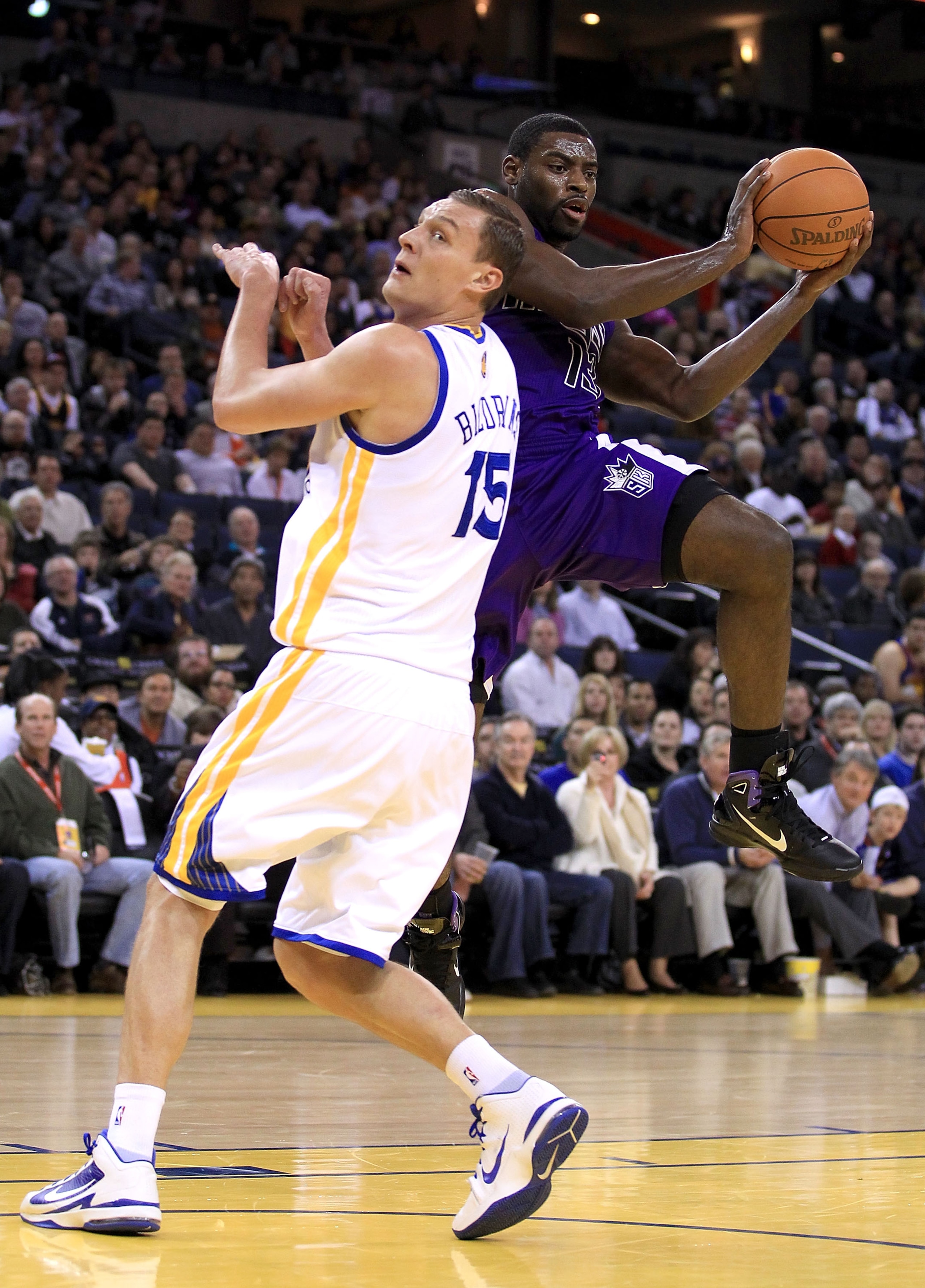 OAKLAND, CA - JANUARY 21:  Tyreke Evans #13 of the Sacramento Kings looks to pass around Andris Biedrins #15 of the Golden State Warriors at Oracle Arena on January 21, 2011 in Oakland, California. NOTE TO USER: User expressly acknowledges and agrees that