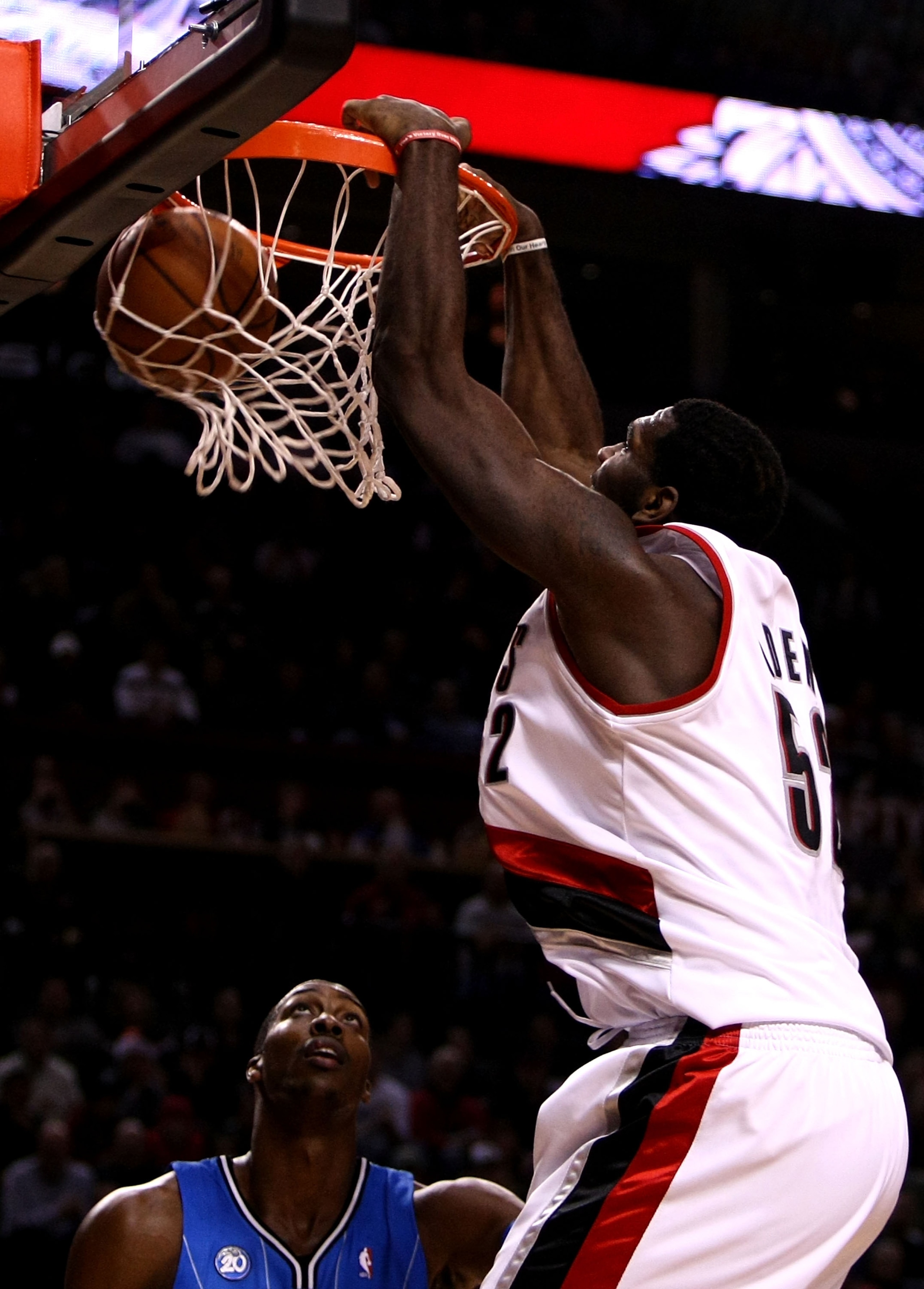 PORTLAND, OR - DECEMBER 09:  Greg Oden #52 of the Portland Trail Blazers dunks over Dwight Howard #12 of the Orlando Magic at the Rose Garden on December 9, 2008 in Portland, Oregon.  NOTE TO USER: User expressly acknowledges and agrees that, by downloadi