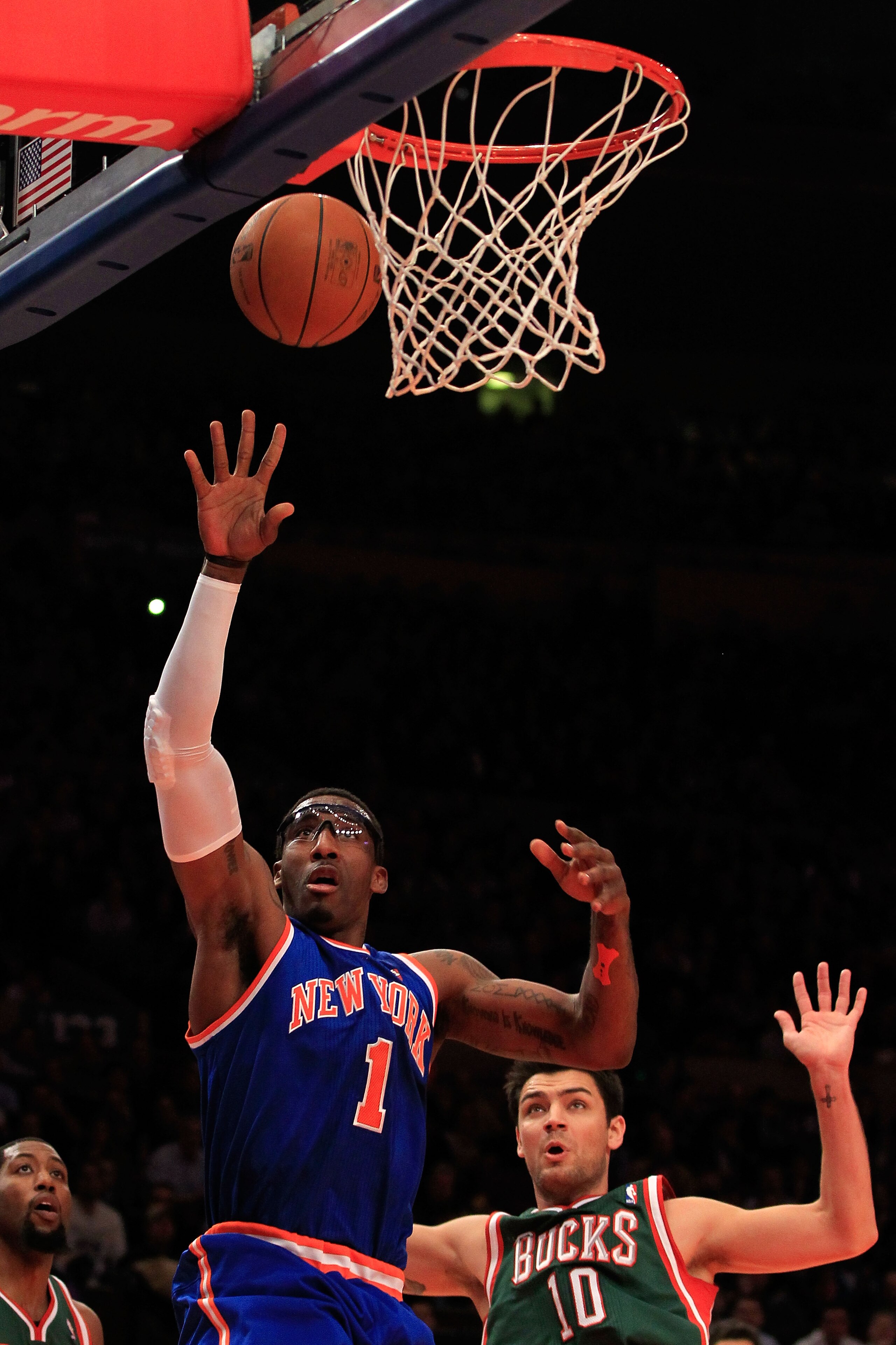 NEW YORK, NY - FEBRUARY 23:  Amare Stoudemire #1 of the New York Knicks shoots the ball over Carlos Delfino #10 of the Milwaukee Bucks at Madison Square Garden on February 23, 2011 in New York City. NOTE TO USER: User expressly acknowledges and agrees tha
