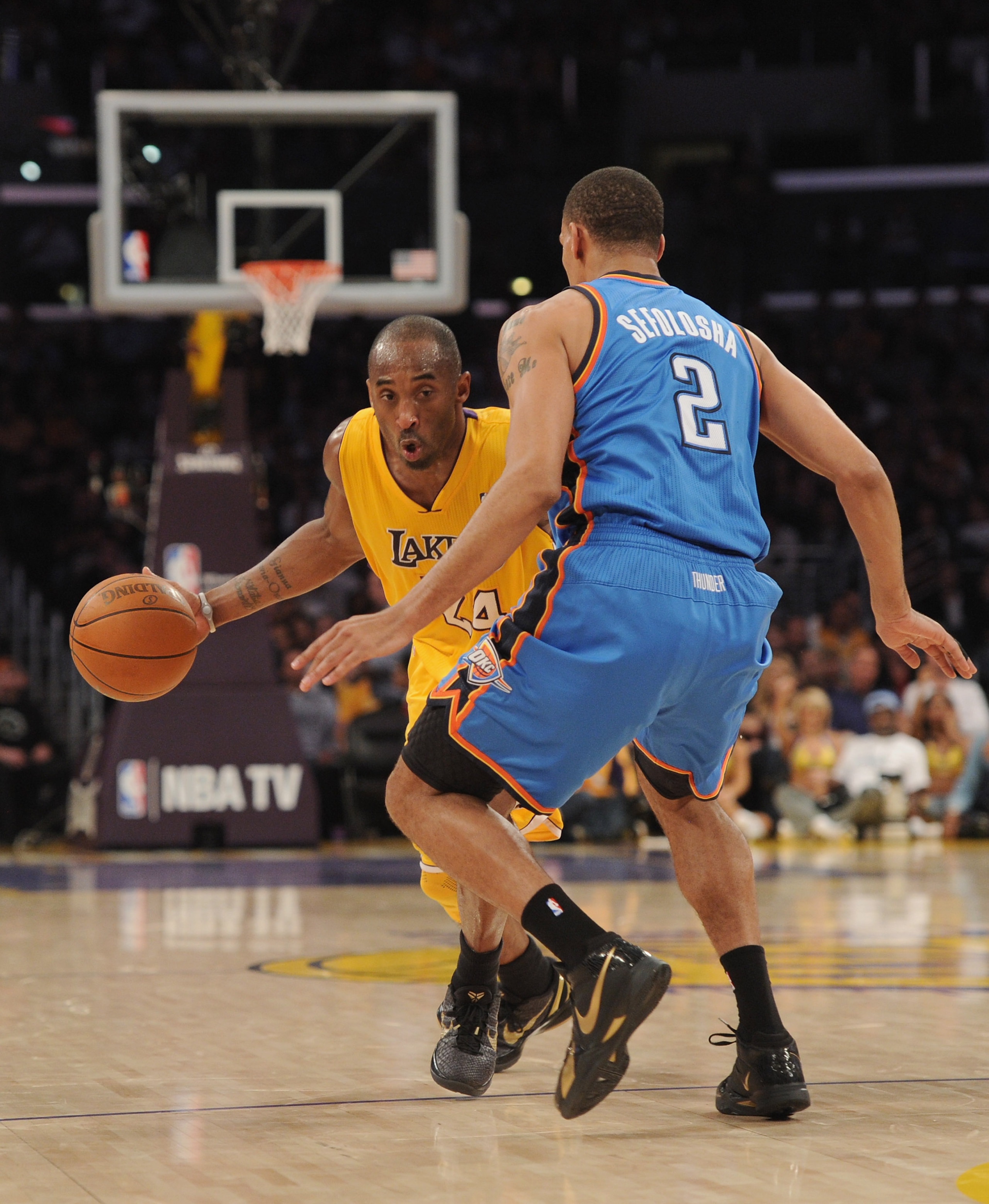 LOS ANGELES, CA - JANUARY 17:  Kobe Bryant #24 of the Los Angeles Lakers dribbles around Thabo Sefolosha #2 of the Oklahoma City Thunder at the Staples Center on January 17, 2011 in Los Angeles, California.  (Photo by Harry How/Getty Images)   NOTE TO USE