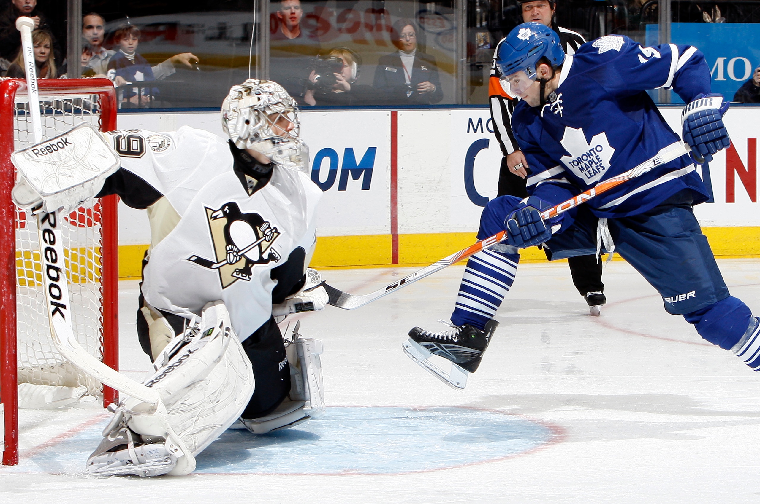 TORONTO, CANADA - FEBRUARY 26: Joffrey Lupol #19 of the Toronto Maple Leafs kicks the puck past Marc-Andre Fleury #29 of the Pittsburgh Penguins during game action at the Air Canada Centre February 26, 2011 in Toronto, Ontario, Canada. (Photo by Abelimage