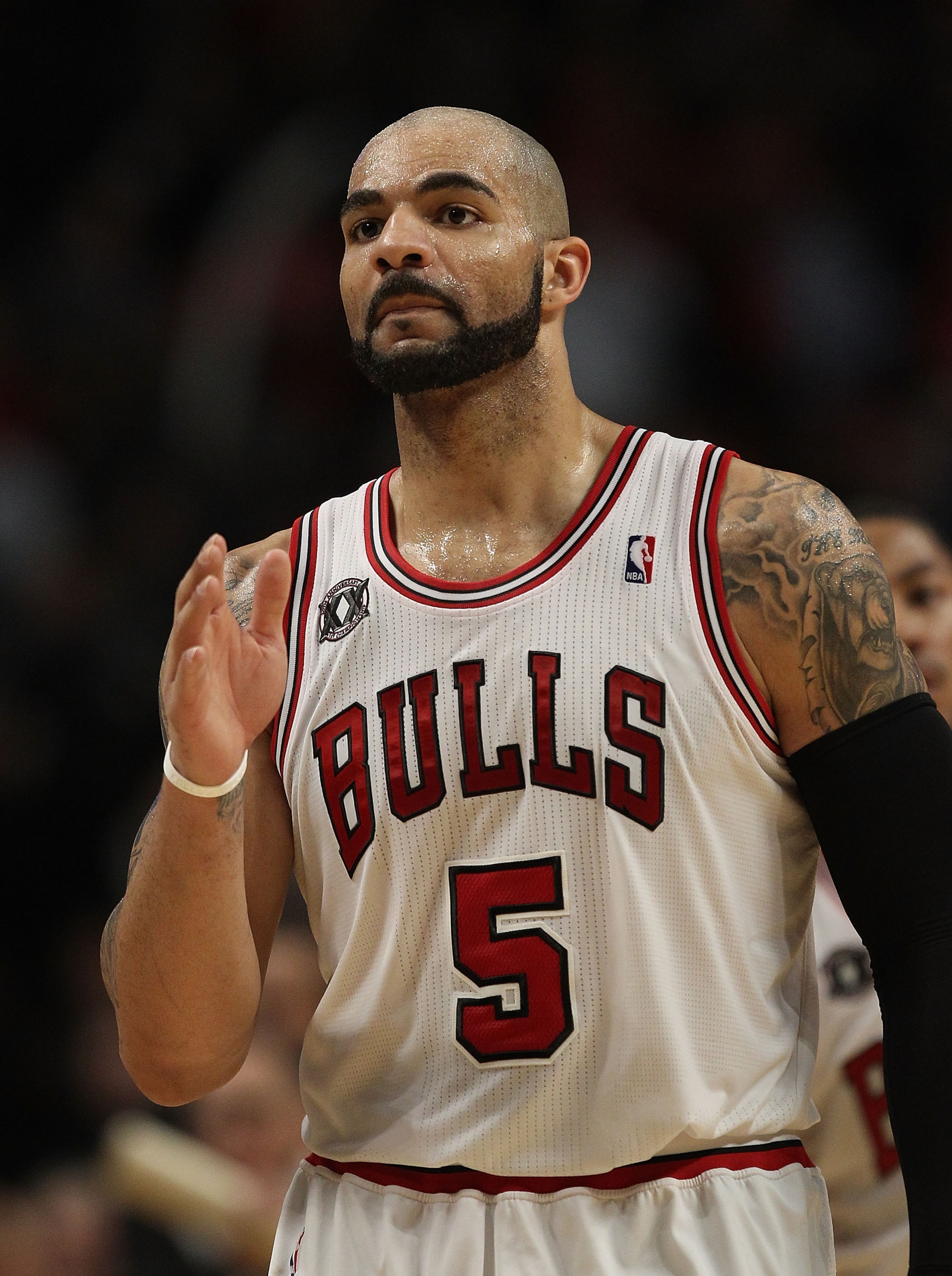 CHICAGO, IL - FEBRUARY 17: Carlos Boozer #5 of the Chicago Bulls waves to members of the San Antonio Spurs after a win at the United Center on February 17, 2011 in Chicago, Illinois. The Bulls defeated the Spurs 109-99. NOTE TO USER: User expressly acknow