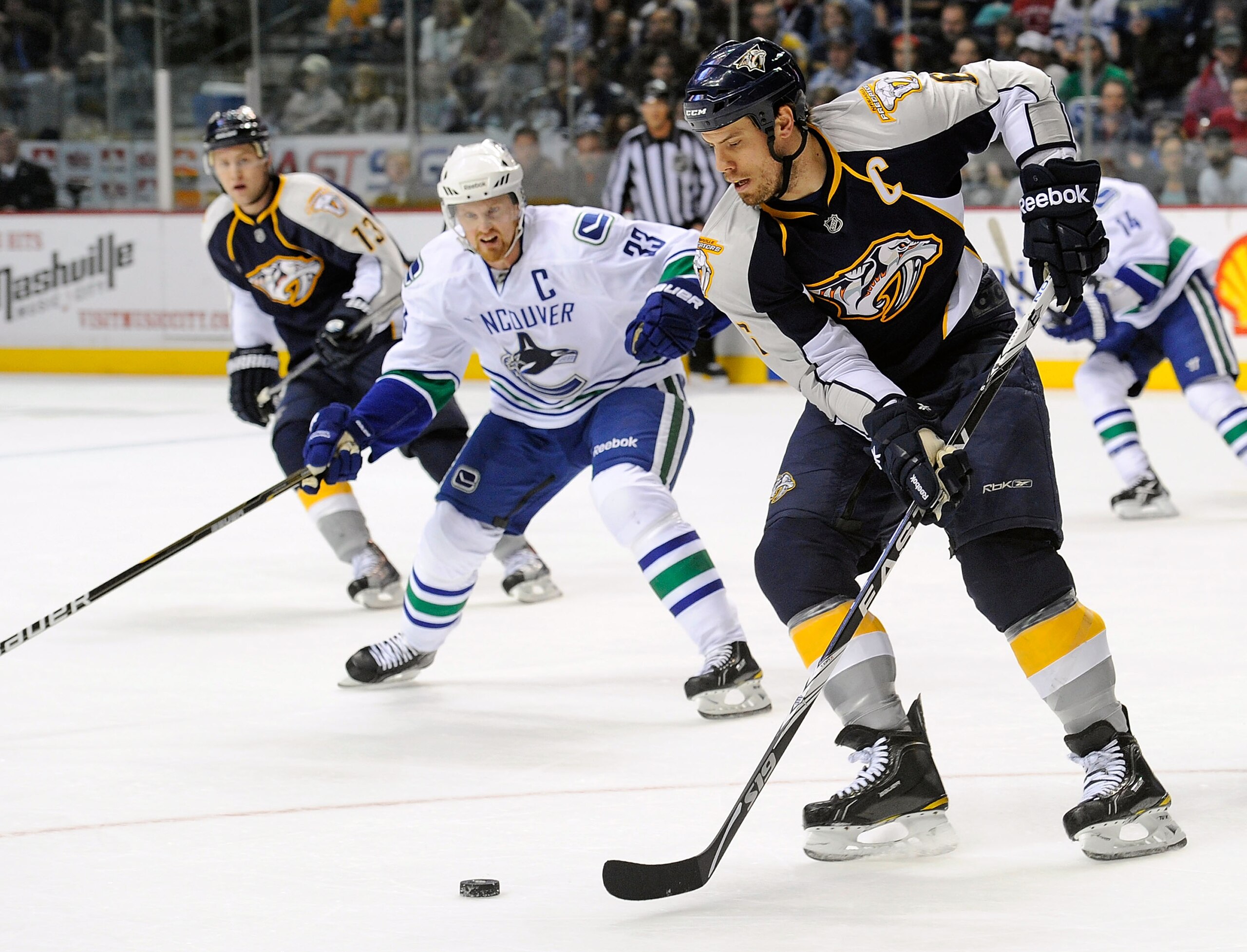 NASHVILLE, TN - FEBRUARY 17:   Shea Weber #6 of the Nashville Predators carries the puck past Henrik Sedin #33 of the Vancouver Canuckson February 17, 2011 at the Bridgestone Arena in Nashville, Tennessee.  (Photo by Frederick Breedon/Getty Images)