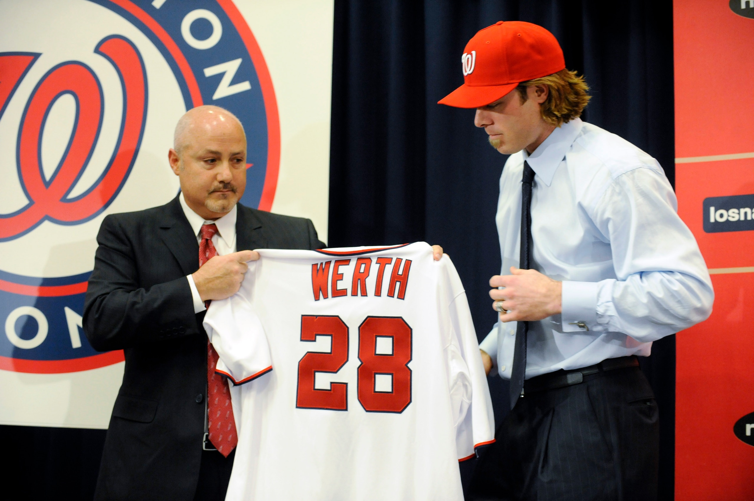 WASHINGTON, DC - DECEMBER 15:  Executive Vice President of Baseball Operations and General Manager Mike Rizzo (L) holds up a jersey as he introduces Jayson Werth #28  to the media on December 15, 2010 at Nationals Park in Washington, DC.   (Photo by Mitch