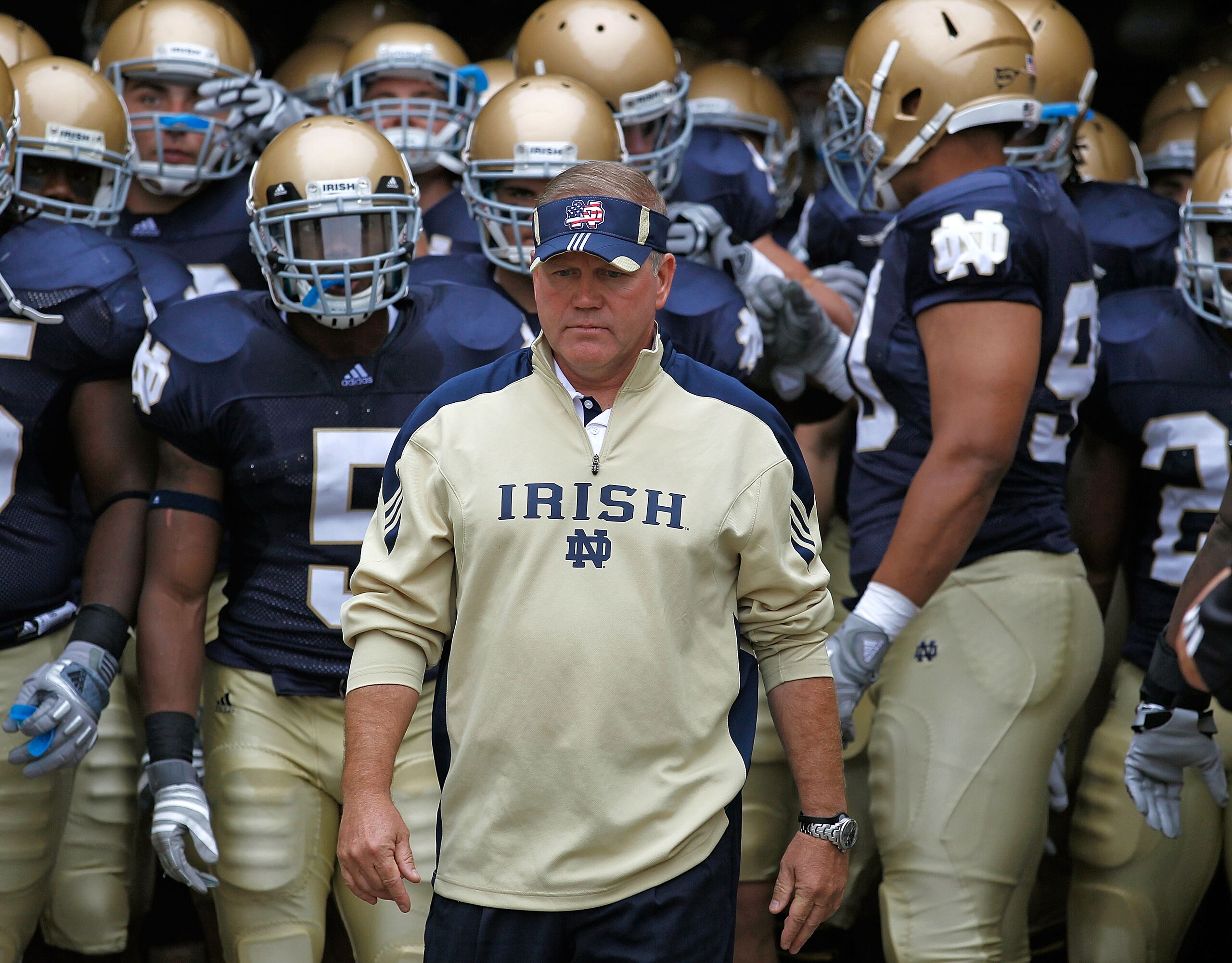 SOUTH BEND, IN - SEPTEMBER 11: Head coach Brian Kelly of the Notre Dame Fighting Irish waits to enter the field with his team before a game against the Michigan Wolverines at Notre Dame Stadium on September 11, 2010 in South Bend, Indiana. Michigan defeat SOUTH BEND, IN - SEPTEMBER 11: Head coach Brian Kelly of the Notre Dame Fighting Irish waits to enter the field with his team before a game against the Michigan Wolverines at Notre Dame Stadium on September 11, 2010 in South Bend, Indiana. Michigan defeat