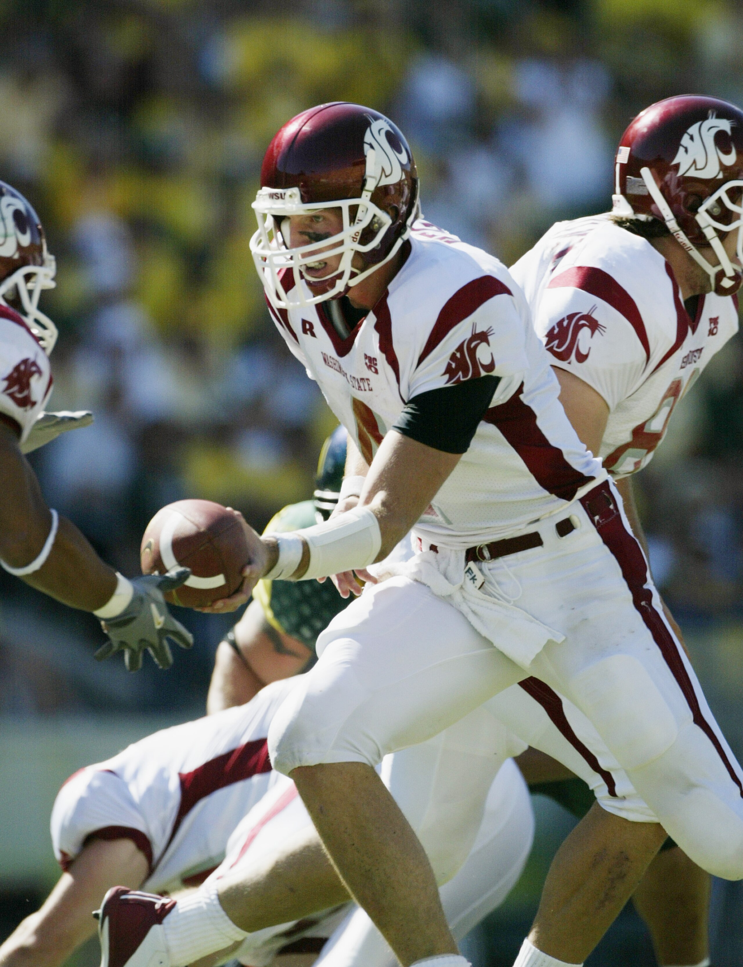 EUGENE, OR - SEPTEMBER 27:  Quarterback Matt Kegel #4 of the Washington State University Cougars goes for the hand off against the University of Oregon Ducks at Autzen Stadium on September 27, 2003 in Eugene, Oregon. Washington State defeated Oregon 55-16