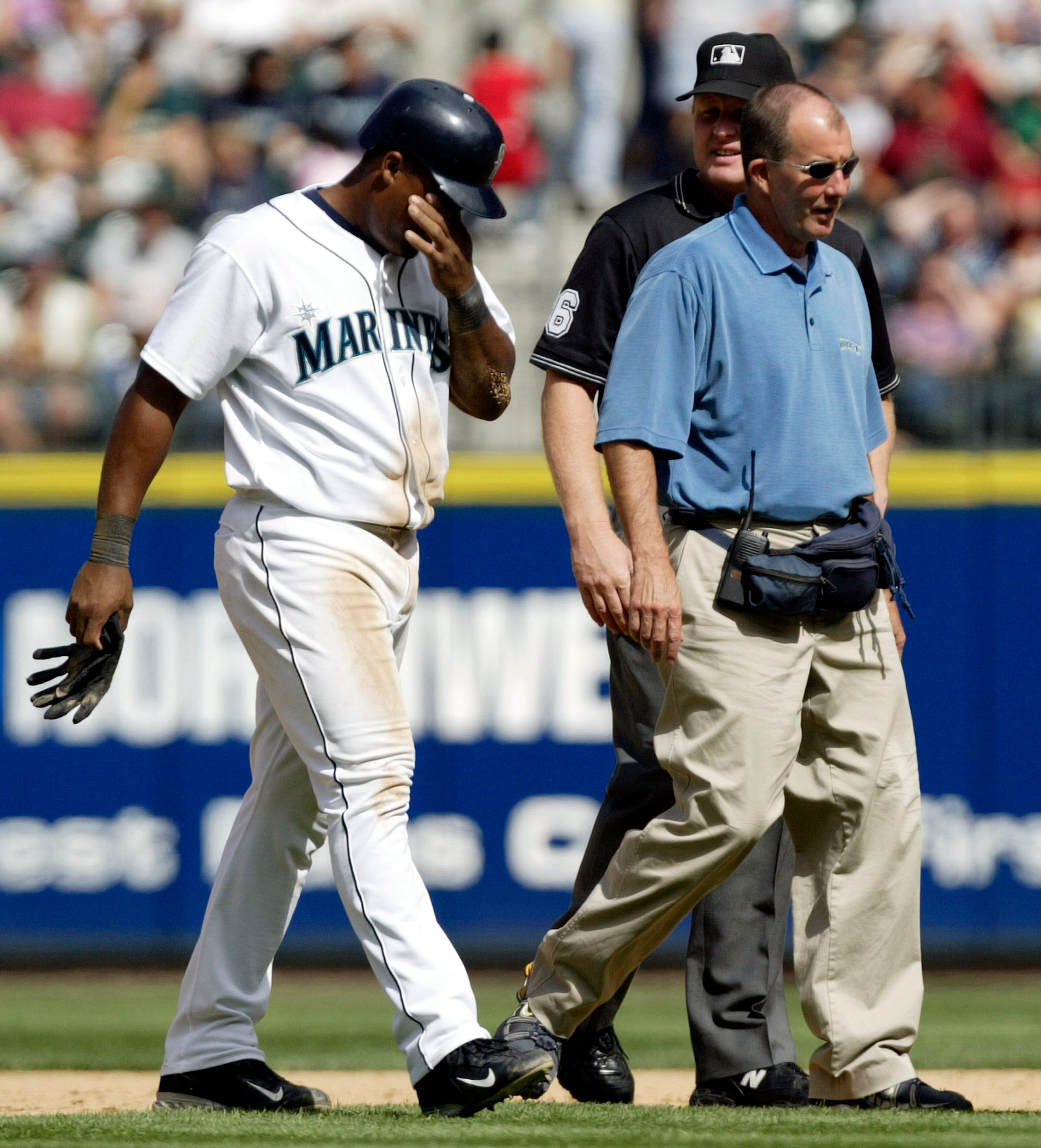 SEATTLE - AUGUST 28:  Adrian Beltre #5 of the Seattle Mariners is escorted off the field by trainer Rick Griffin after suffering an injury in the fifth inning against the Chicago White Sox on August 28, 2005 at Safeco Field in Seattle, Washington. The Mar